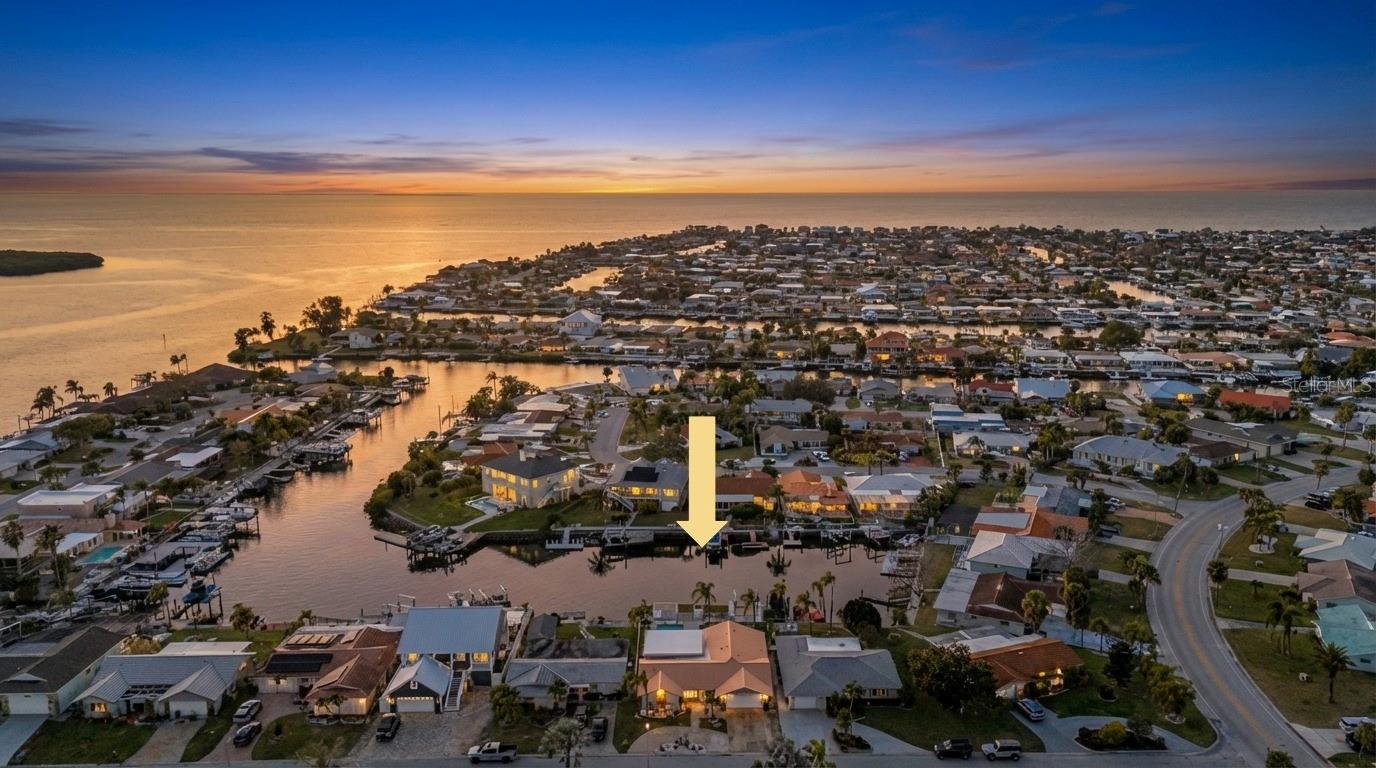 NEW PRICE WELL BELOW MARKET VALUE!  WATERFRONT PARADISE! Deep Water Access & 2025 Fully Remodeled Home. Experience the ultimate Florida lifestyle in this WATERFRONT estate located in Beautiful Gulf Harbors. Boasting 65 feet of waterfront & seawall on a deep-water canal with no bridge restrictions & just a 5-minute boat ride from the open waters to the Gulf of Mexico. There is nothing you will need to add! You'll love the tropical landscaping and paver pathway along with the recently painted soothing blue exterior of the home.  You’ll be greeted by a convenient circular driveway, offering ample parking for guests and your watercraft toys. Step inside to this 3 Bed, 3 Bath with/Office, you'll immediately be captivated by the stunning view that extends straight through to the pool and tranquil canal waters. The home's open floor plan seamlessly blends modern design with comfortable living. The fully remodeled kitchen, completed in 2020 with Brand New Appliances in 2025, is a chef's delight, featuring a center island w/quartz countertops, breakfast bar, farmers sink, gorgeous tile backsplash, pendant lights, and abundant storage making this the perfect home for Entertaining. The split floor plan provides privacy and convenience, with the primary suite tucked away on the far side of the home. This primary retreat boasts a gorgeous ensuite bath completed in 2025 with dual sinks, soaking tub and frameless shower along with large walk-in closet with custom cabinetry. On the opposite side of the home, you'll find two generously sized bedrooms. One with a walk-in closet & also with custom cabinetry. The other bedroom was used as an office the the closet doors & shelved can just be added.  Both Bedrooms share a well-appointed updated bathroom, offering plenty of storage space with the Quartz Vanity, providing a shower w/tub. The Sellers also created a wonderful office with French doors adding plenty of natural light in from the foyer and brand-new front door. The newly added bonus room in November 2023 is an entertainer's dream adding 500sq feet, providing ample space for Entertaining and easy access to the pool through the impact resistance sliding glass doors. The outdoor space is equally impressive, with a saltwater pool, perfect for pool volleyball 3.5 feet deep on the ends and 6 feet deep in the middle for fun on those hot summer days. It also has a new pool pump. You’ll appreciate that you still have a backyard with grass for your pet’s enjoyment and the large pool does not take up the entire backyard like most homes here. The stationary, floating dock and 13,000-pound Boat Lift with wrap around decking were replaced in 2022, making it easy to embark on your next boating adventure. There is also a full Pool Bath for cleaning up after your boating adventures right off the pool. Also, the 2 Car Garage was renovated with new drywall, an impact resistant door, new mini split & fully insulated keeping it cool to use as an additional room in the home. 16Seer AC 2020, bonus room mini split 2023, 2020 Home Inspection gave roof 16+ years of life. Additionally, residents have the option to join the exclusive Gulf Harbors Membership, granting access to a private park and beach, perfect for enjoying the Florida sunshine. This home has been impeccably designed and cared for and you will love it! Don't miss the opportunity to make this waterfront oasis your own. Beach Club $200 a year.  Schedule a showing today and start living the Gulf Harbors lifestyle!