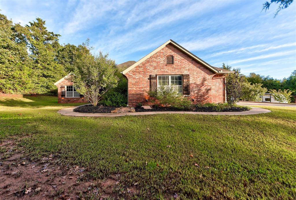 Quaint, private country-styled niche with all the city amenities.  Landscaped single story ranch on an acre in a quiet family neighborhood within 15 minutes of downtown Edmond.  Open style with large living, study and formal dining.   Breakfast nook and bar leading into a chef's dream two oven, large island, walk-in bricked pantry with granite on every surface.  Large master bedroom with double door exit to the wrought iron fenced back yard  leading right up to the forest.  Master bath with garden tub, separate sinks, walk-in shower and door to 13'x8' walk-in closet.    Laundry room with cabinets and full-size pet washing station.  Whole house water filter, water softer and well-water.