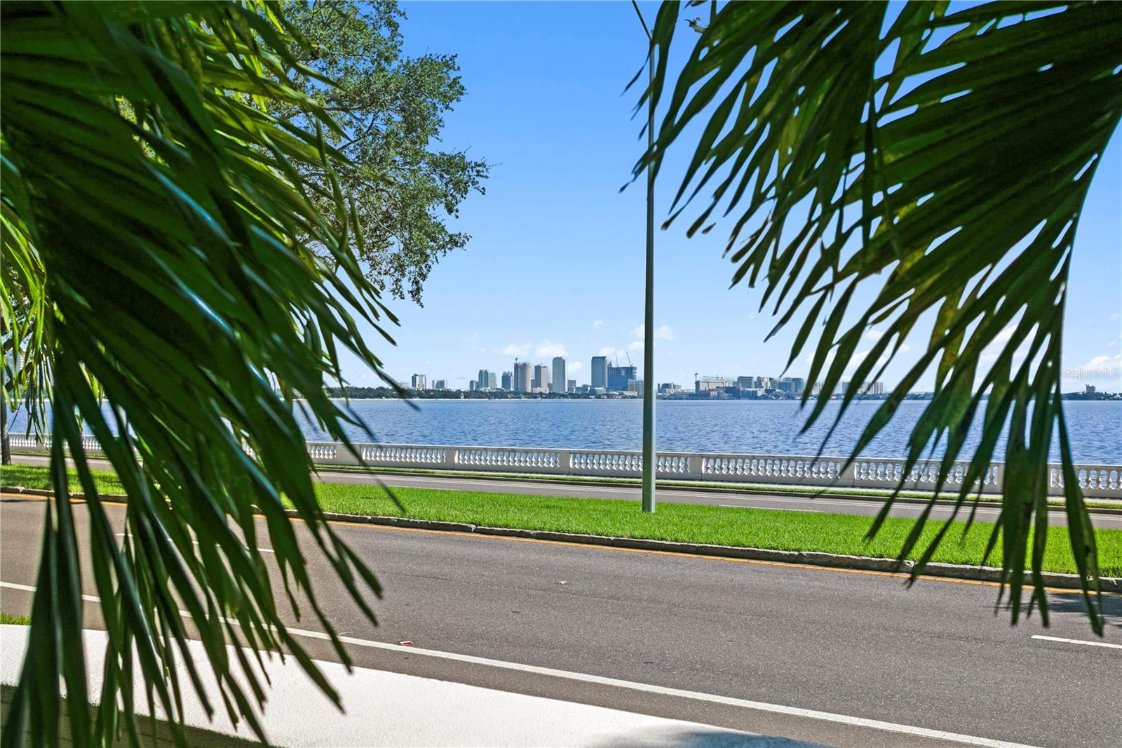 PRIVATE ENTRANCE 5 BEDROOM TOWNHOME WTH CONDO AMENITIES ON BAYSHORE BLVD. Exceptional opportunity awaits at The Alagon. This is your opportunity to own one of only 3 "City Home" TOWNHOMES ON BAYSHORE BLVD.NOTHING ELSE compares to the privacy and comfort of a luxury townhome with 2 CAR GARAGE and the unparalleled amenities and services of one of Tampa’s premier waterfront residences.Beautifully updated and impeccably appointed, this extraordinary five-bedroom, five and a half-bath residence is the epitome of timeless elegance and sophisticated design. Every detail has been thoughtfully curated, from the grand staircase and designer lighting to the exquisite finishes found throughout. Bonus to have a full en-suite bedroom downstairs for guests or multi generational living. Upstairs primary includes a sitting area, a separate office or nursery, spectacular primary spa bath with floating tub and walk-in shower, extra large walk-in closet with additional built-in storage and Bayshore views from every angle. Covered balcony makes this the perfect place to enjoy morning coffee.Designed for both the passionate chef and the consummate host, the spectacular gourmet kitchen serves as the heart of the home, offering exceptional craftsmanship, premium appliances to include Wolf induction cooktop, DUAL SUB-ZERO REFRIGERATOR WITH BEVERAGE DRAWERS, DOUBLE WOLF OVENS, wine refrigerator, ice maker, and generous open floorplan for entertaining on any scale. One touch controls for lighting, electric shades, whole house entertainment. Electric fireplace sets the perfect backdrop for sophisticated entertaining.French doors and breathtaking views enhance nearly every room, filling the home with abundant natural light while creating a seamless connection to the beauty of Bayshore Boulevard. Expansive living spaces provide an effortless blend of refinement and comfort.Enjoy the rare advantage of a detached residence complete with a private two-car garage, while indulging in the full-service lifestyle and exceptional amenities offered by The Alagon. This is a 24 hour concierge building for added security and privacy. Gym, pool, card/game room in condo tower and furnished guest suites. Truly one-of-a-kind opportunity to experience luxury living at its finest—exceptional in every way.