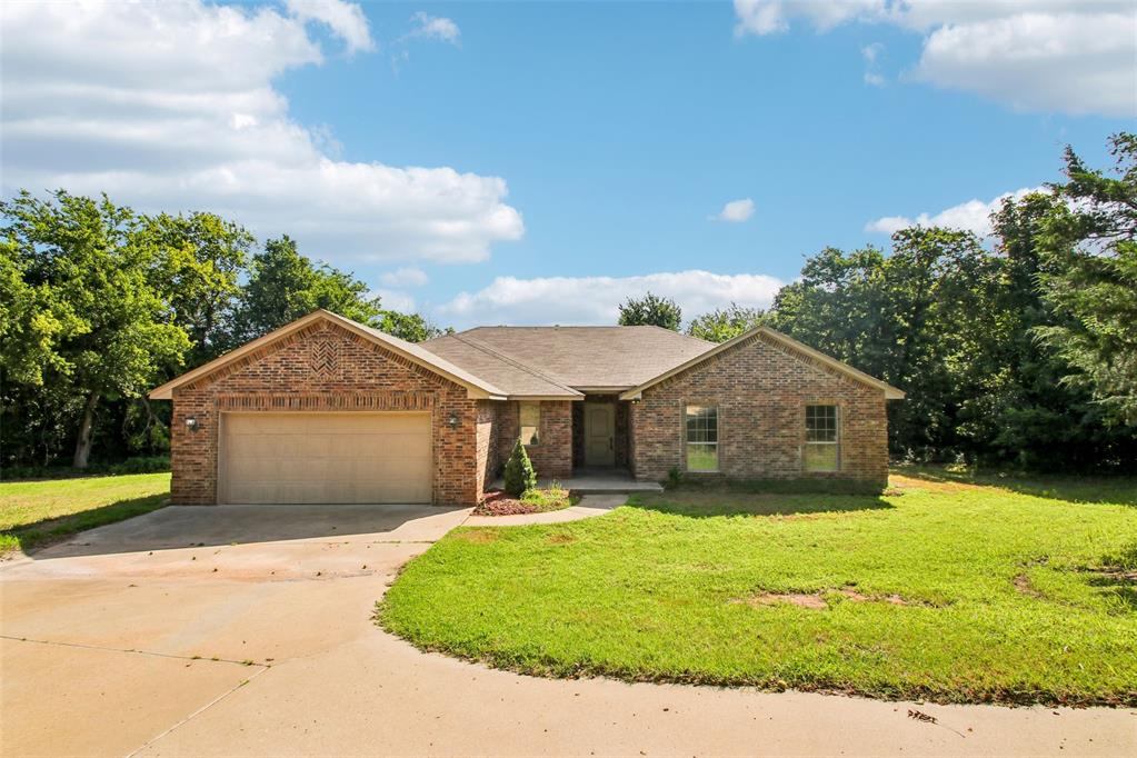 12702 Fox Pass Rd is a one-story Edmond home built of brick in 2013 on a cul-de-sac lot. The kitchen centers on an island with granite countertops and stainless steel appliances, opening to a living room framed by a brick fireplace and connected to the main gathering space. The bedrooms are carpeted, and the primary bedroom includes a tray ceiling, a walk-in closet, and a bathroom with a double vanity and a tub and shower. A dedicated laundry room adds function on the main level, and the backyard provides open lawn space behind the house. A two-car garage rounds out the layout with parking and storage throughout this single-story home. Included 100-Day Home Warranty with buyer activation.