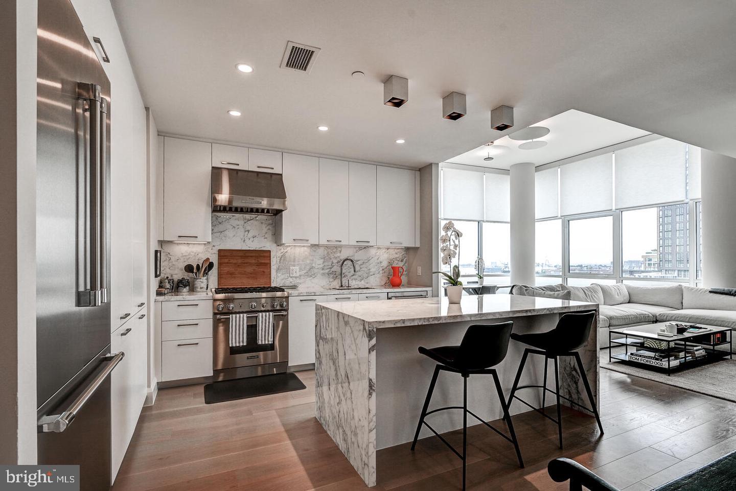 Experience luxury  living at Baltimore’s  Liberty Harbor East. This stunning 2-bedroom, 1-bathroom property offers elegance and sophistication across 1,200 square feet. This corner unit is flooded with natural light, highlighting its exquisite design and beautiful views through floor-to-ceiling windows. Enjoy the state-of-the-art open kitchen, showcasing Italkraft custom cabinetry and premium Thermador appliances, including a 4-burner gas range and MicroDrawer microwave. The spacious waterfall island seamlessly connects to the living area, perfect for entertaining. The primary bedroom suite features a generous walk-in closet and a spa-like master bath equipped with Kallista and Kohler fixtures, Carrara marble flooring and walls, and a spacious dual vanity.  A second bedroom is an ideal space for a guest room, study, office, or a quiet retreat.  Tenants can enjoy Liberty’s exclusive amenities including an outdoor pool with cabanas and courtyard seating, grilling stations,  fitness center, yoga studio,  pet park, lounge area,  a catering kitchen and private dining area, and conference rooms.  Embrace the vibrant downtown lifestyle with easy access to entertainment, shopping, dining options, parks, and waterfront walking paths and activities.  Come visit this beautiful property today.
