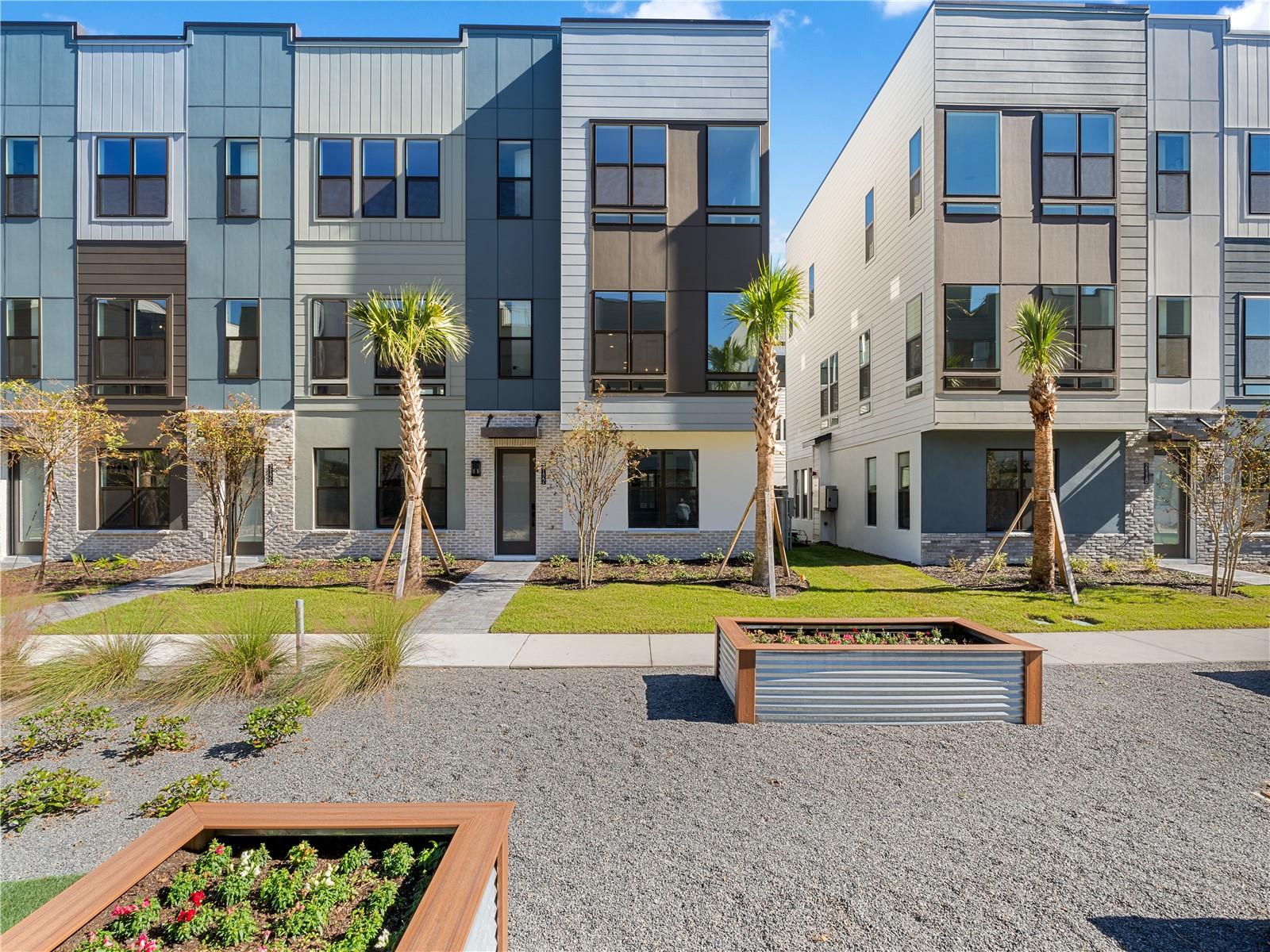 MOVE-IN READY Luxury Townhome with Rooftop Terrace in The Packing District!
Welcome to a lifestyle of comfort, convenience, and modern elegance. This 4-story, move-in ready townhome is designed for effortless living and entertaining in one of Orlando’s most exciting new communities — The Packing District. On the first floor, you’re greeted by a private bedroom with its own ensuite bath — perfect for guests, a home office, or multigenerational living — along with a spacious two-car garage. The second floor is your main living area, featuring an open-concept layout with a gourmet kitchen, casual dining area, and a light-filled great room perfect for relaxing or hosting. You'll love the upgraded brown cabinetry, quartz countertops, stunning white tile backsplash, and included natural gas KitchenAid appliances — all thoughtfully selected to elevate your day-to-day living. Head up to the third floor, where you’ll find the primary bedroom retreat, a secondary bedroom, and a walk-in laundry room for ultimate convenience. And then, the crown jewel,  the fourth-floor rooftop terrace. Your private outdoor oasis comes equipped with pre-installed prep packages ready for a future summer kitchen, fireplace, and even a hot tub. Imagine sunset dinners, weekend lounging, and unforgettable evenings under the stars — all from the comfort of home. Interior upgraded finishes throughout include: Engineered hardwood stairs, Tile flooring in main living areas, Luxury vinyl in all bedrooms, Quartz countertops and upgraded cabinetry, ALL appliances included. The on-site model home showcases a similar layout and finishes — we invite you to come and experience it in person! Living in The Packing District means so much more than just having a beautiful home, it’s about embracing a dynamic, connected lifestyle. Start your day with a peaceful walk or bike ride along the scenic 1.5-mile trail, then grab a slice at the food hall or break a sweat at the brand-new YMCA. Meet up with friends for a competitive game of pickleball or tennis at the Orlando Tennis Center — all just steps from your door. And the amenities don’t stop there. The Packing District is growing into one of Orlando’s most exciting new communities, featuring a new Publix, rock climbing facility, Hotworx Studio, and the innovative 4Roots Farm Campus. With future office and retail spaces also in the works, everything you need — from wellness to convenience to recreation — is right at your fingertips.