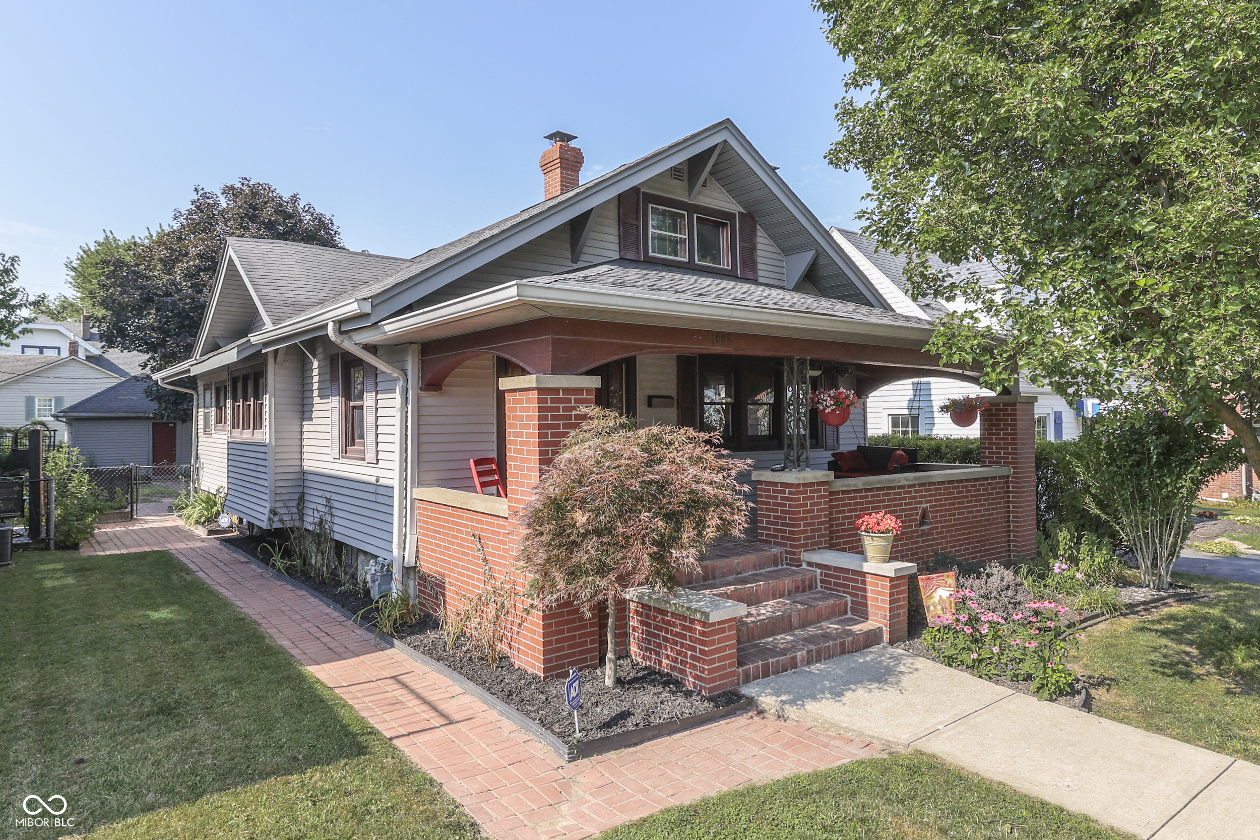 Beautiful Craftsman home on "Main Street USA". Original built-in china cabinets in the formal dining room. Original Ok double-nailed hardwood floor on main level, pine upstairs. Gorgeous kitchen with original built-in booth seating and all appliances stay. Original trim, doors, and an arched doorway. You will love the covered front porch, and the rear deck with trellis too. 4-BR (2-main & 2-up for young ones) and a full, dry basement with a finished family room, a 2nd kitchen, and plenty of rooms for storage ... wow! There is a 2-car garage on the alley and 2-more paved parking spots; overflow parking for guests is convenient on Main Street, and right around the corner. Relax ... This home has been well maintained and features new A/C and water heater within the last year; new roof and furnace within the last 10 years.