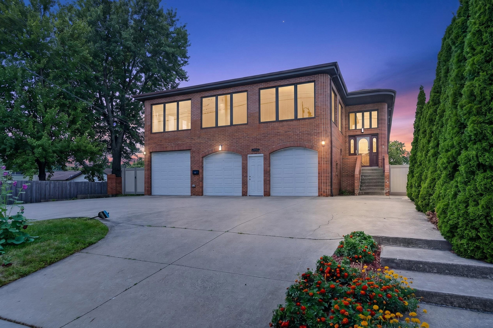A rare, one-of-a-kind residential masterpiece! Welcome to 1046 S Main St, a grand, all-brick estate delivering unparalleled space, luxury, and versatility in Lombard. Perfect for multi-generational living, a premier home business, or an avid car collection, this massive property features 6907 sq ft of living area, consisting of about 1,200 square feet of open space on the ground level just waiting for your creative vision to configure as desired! Superbly located, the home is just steps from Glenbard East High School, and convenient to the Lombard Metra, making it an incredible opportunity for a growing household and commuters. This desirable, east-facing home fills with beautiful morning sunlight and features dramatic 10-foot ceilings on the first floor and 9-foot ceilings on the second floor, accentuating the sheer scale of the home. The main level is anchored by grand, entertainment-sized rooms designed for unforgettable hosting. The true showstopper is the jaw-dropping 800+ square foot second floor sunroom/party room (36x23 ft), featuring soaring beamed ceilings and panoramic windows on three sides that flood the space with natural light. With a sprawling layout offering 7 bedrooms and 4 full bathrooms, there is still abundant space to easily add more suites if desired. The home features a spacious 3-car garage equipped with an EV charging station. Private balconies off the eat-in kitchen and Primary Suite offer sweeping views of the fully fenced backyard oasis, which features beautiful, mature landscaping and thriving fruit trees. Back inside is a bonus area that could be used as a wine cellar, storm shelter, or just additional storage.  Combining massive above-grade square footage, endless floor plan flexibility, and an unbeatable location, this brick giant is a generational find. You have not seen anything like the construction and size of this unbelievable home!