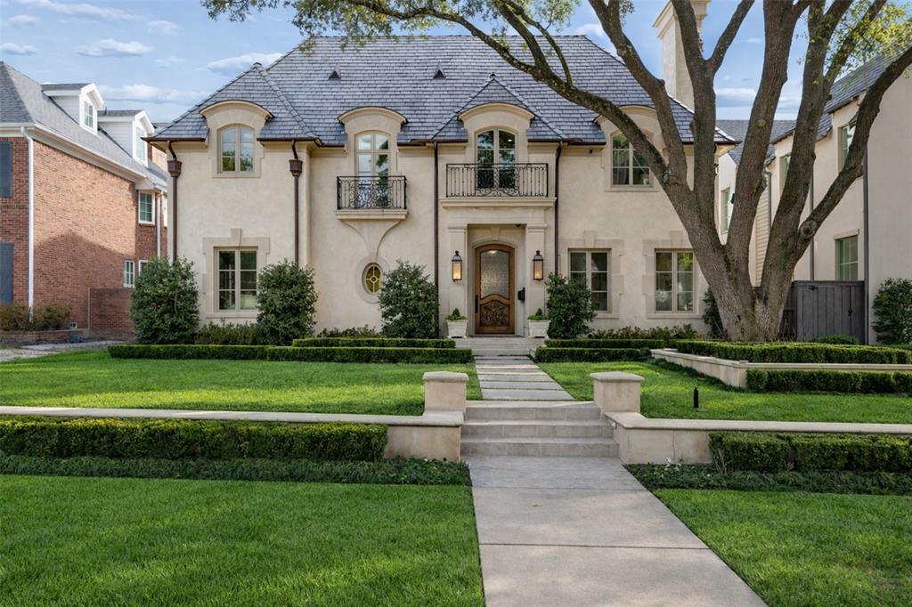 Experience elevated living in this immaculate Highland Park residence, blending timeless luxury with everyday livability. Designed to feel refined yet welcoming, the home features an open, light-filled floor plan ideal for entertaining and daily living.Offering 6 bedrooms, 6.2 baths, and five fireplaces, the interiors are richly appointed throughout. The chef’s kitchen is a true centerpiece with Wolf appliances, a built-in Sub-Zero refrigerator, a Miele coffee system, and seamless flow into a temperature-controlled wine cellar connecting both the kitchen and formal dining room. The dining room is a standout with Venetian plaster walls and a fireplace, creating an elegant setting for gatherings.The spacious primary suite serves as a serene retreat with fireplace, private patio, spa-inspired bath with dual water closets, oversized walk-in closet, soaking tub, and walk-in shower. All secondary bedrooms feature en-suite baths and walk-in closets. A second-level mini kitchen adds convenience.Additional highlights include leathered bar ceilings, a private first-floor office, and French doors opening to landscaped grounds with artificial turf for seamless indoor–outdoor living. A custom mudroom leads to the epoxy-finished garage. The home sits on a 65 x 150 lot and is crowned by a Premium DaVinci slate-style roof.A detached back house, not included in the square footage, features a golf simulator on the first level and a private movie theater on the second, and can easily convert back to a three-car garage. Additional amenities include a built-in grill, integrated audio, and camera system. Zoned for Armstrong Elementary. A rare opportunity to enjoy refined comfort, thoughtful design, and premier walkability in the heart of Highland Park.