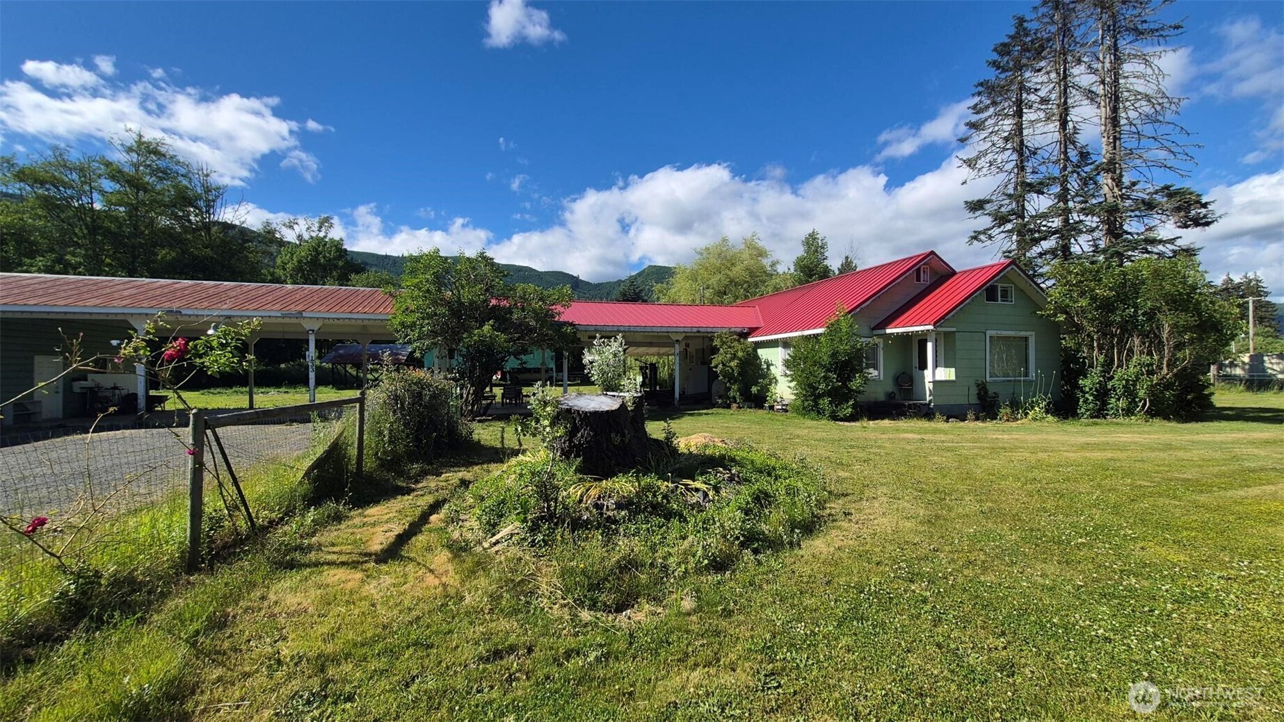 Nestled beneath breathtaking mountain views, this well-loved 3-bedroom, 1.25-bath home offers the perfect blend of comfort, functionality, and peaceful country living on 1.35 beautiful acres. The home features a spacious floor plan with inviting living and dining areas, abundant natural light, and a bright kitchen with ample cabinetry and generous counter space. Newer windows and an energy-efficient heat pump provide year-round comfort and efficiency. Step outside to enjoy the expansive covered patio, creating the perfect setting for outdoor gatherings, morning coffee, or simply taking in the serene surroundings. The property is well-equipped for hobbies, storage, and recreational needs with a large, detached shop, RV cover, and additional covered parking. There's plenty of room for gardening, animals, outdoor activities, or simply enjoying the open space and privacy this special setting provides. Whether you're searching for a full-time residence, mountain getaway, or property with investment potential this charming home offers endless possibilities in a picturesque setting you'll love. Experience the warmth, character, and tranquility of a home that has been cherished and cared for, ready to welcome its next owner. A little elbow grease will make it shine.