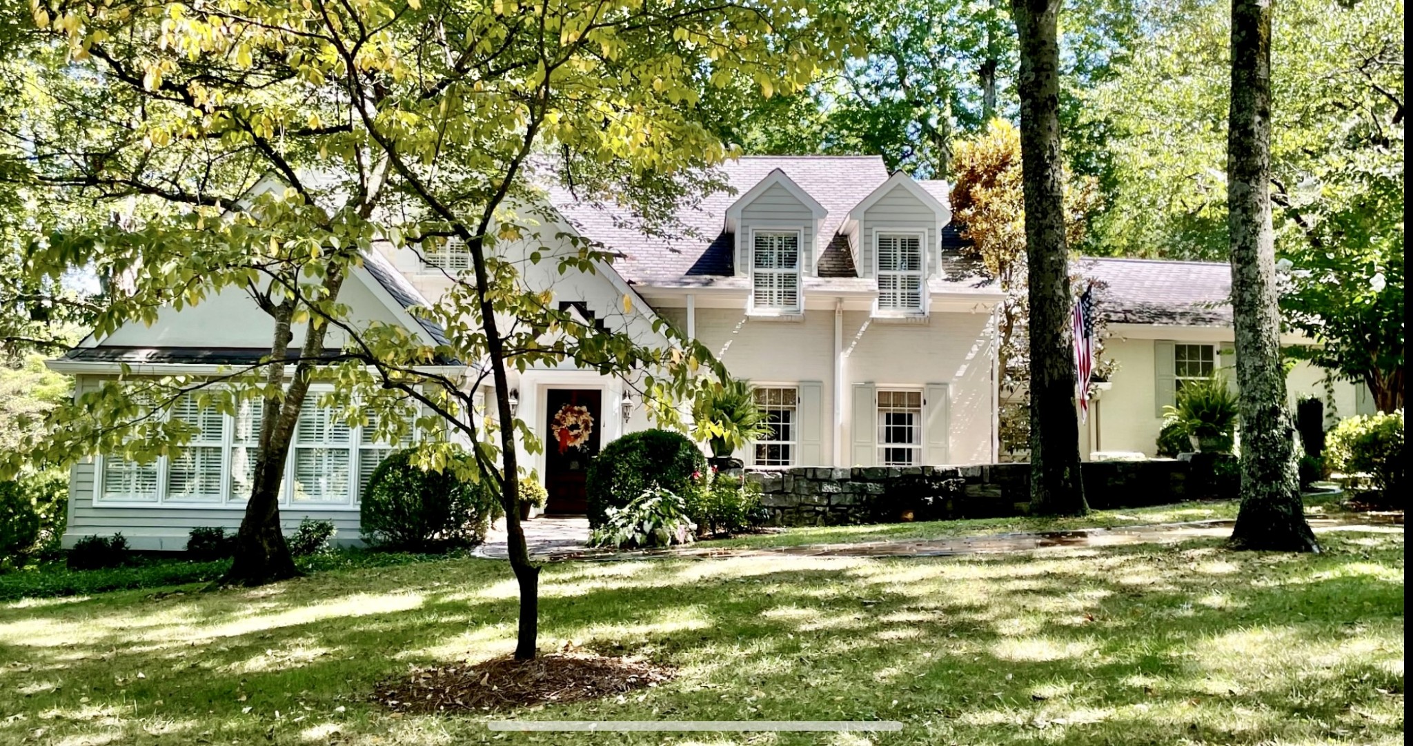 A charming and chic 1922 Belle Meade home tucked back on a coveted street has a storybook curved stone pathway that leads to a concealed front courtyard. It is a seamless blend of vintage elements and modern conveniences meticulously cared for over the years. Light-filled rooms with classic moldings and millwork, top-notch kitchen appliances, island, sunny breakfast area, and 3 fireplaces: 2 with striking marble-surrounds, & 1 shiplap-wrapped, all adds a posh touch.The exquisite dining room with designer wallpaper, an inviting living room, a stunning vaulted sunroom, a clubby den with bookcases & primary bedroom suite, are all located on 1st floor! Vaulted and 8-9’ ceiling height, allow for intimate or larger entertaining. Upstairs, 3 generous bedrooms, 2 full baths & attic.The serene back terrace and elevated seating area will delight guests to gather around a cozy fire pit or enjoy the tranquil surround under towering magnolias and other mature trees hydrated by a 14-zone irrigation system. The City of Belle Meade is privileged to have its own police force! This is a classic southern gem!