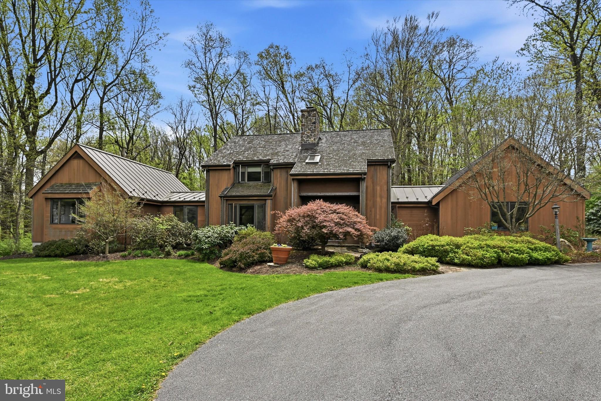 Nestled on approximately 6 private, picturesque acres in the heart of Kennett Square, this one-of-a-kind 3-bedroom, 2.5-bath Hugh Lofting timber frame home, designed by renowned architect Art Bernardon, offers a rare blend of architectural beauty, tranquility, and modern comfort.From the moment you arrive, you’ll be captivated by the peaceful setting, surrounded by nature and enhanced by custom walking trails thoughtfully created by the current owner. Inside, the home showcases timeless craftsmanship with warm wood tones, soaring ceilings, and a stunning sunken living room anchored by a striking stone, wood-burning fireplace perfect for cozy evenings. Adding to the home’s character, the living room features custom walnut cabinetry crafted from trees harvested right from the property, creating a truly unique and meaningful design element.The kitchen is both functional and inviting, featuring a blend of butcher block and granite countertops, ideal for everyday living and entertaining. Just beyond, a spacious rear deck provides the perfect place to relax and take in the breathtaking views and unmatched privacy.The main level offers the convenience of a first-floor primary suite complete with an ensuite bath. Just before entering, a light-filled sitting room creates a peaceful transition into the space, offering beautiful views of the front yard and direct access to the rear deck, an ideal spot for morning coffee or quiet reflection. Additional bedrooms and a versatile loft area on the second floor provide flexible living space ideal for a home office, guest space, or potential fourth bedroom.Additional highlights include a large dedicated office, a 3-car attached garage with a floored attic for ample storage, and an unfinished basement with direct access to the garage, offering endless potential for future expansion.This extraordinary property is a true retreat where thoughtful design meets serene country living, all just minutes from the charm, dining, and culture of downtown Kennett Square.