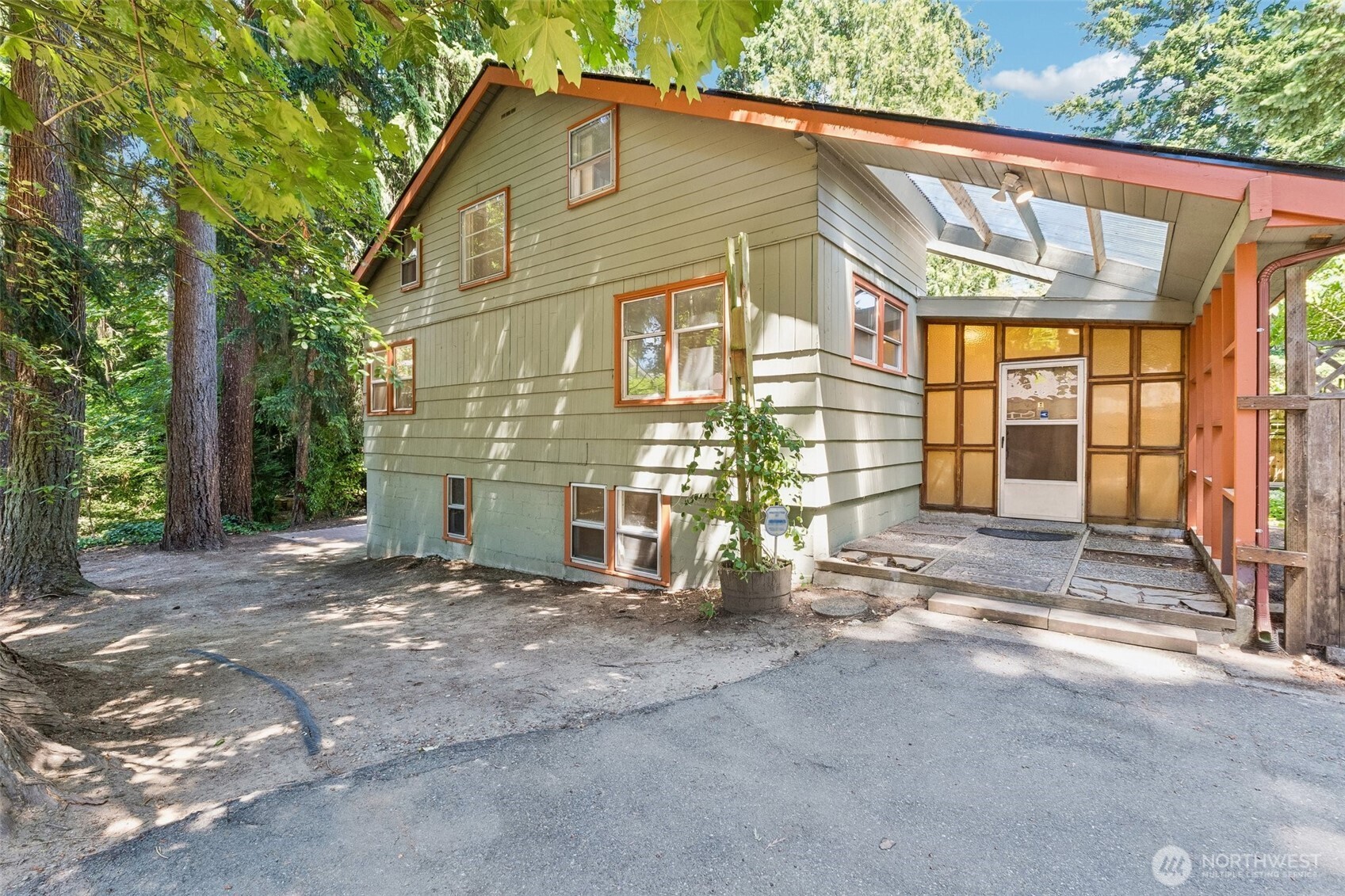 Rare opportunity in Edmonds. Hidden from the street and tucked away on an expansive, private 0.4-acre lot, this spacious 2,100 sq. ft. home provides room to stretch inside and out. Main level includes a huge front room, a generous living room and large kitchen with eating area. New plank flooring and carpet througout and large windows to show off the oversized lot. 2 bedrooms plus full bath on the main and 2 smaller bedrooms up. The partially finished basement awaits your ideas. It includes bonus room, 3/4 bath and extensive storage. Improve to more living space or keep as-is shop, storage and home projects. Enjoy the large deck off the kitchen plus a firepit situated in the center of your private forest. One car garage plus extensive off-street parking for cars/boats/rv's. Just minutes by car to downtown Edmonds and waterfront beaches. Great shopping nearby as well. Highly rated Edmonds schools. Quick access to I-5 and a short walk to multiple bus lines. 1 mile to Ballinger Park. 3 miles to MLT light rail station. Plus development possiblities. Preliminary short plat approved in 2010 (now expired). Buyer to verify current possibilities.