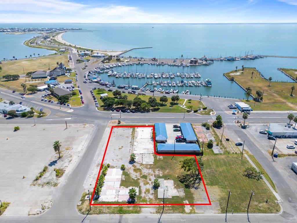 Prime Commercial Lots in the Heart of Downtown Rockport – Coastal Charm Meets Investment Potential...Seize a rare opportunity to own 6 contiguous commercial lots (Lots 6–13) in the vibrant heart of Downtown Rockport, nestled within the sought-after Rockport Cultural Arts District. Perfectly positioned next to the brand-new Aransas County Courthouse and just steps from the bustling marina, this premier location offers exceptional visibility and foot traffic year-round. These ready-to-build lots boast breathtaking water views and are surrounded by art galleries, boutique shops, and coastal eateries—making them ideal for a variety of developments including retail, hospitality, office space, or mixed-use concepts. With the charm of coastal living and the energy of Rockport's thriving arts and business scene, this is more than just a land investment—it's a chance to be part of the community's next chapter.