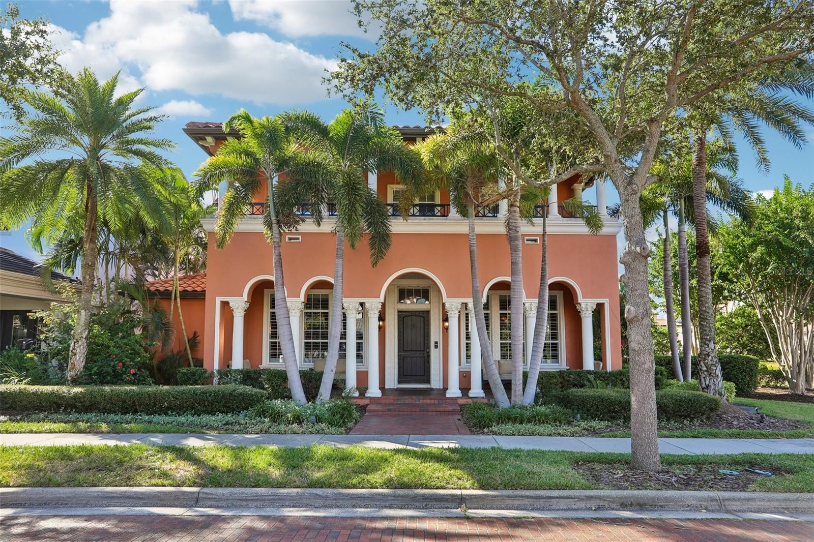 Welcome to 4912 Yacht Club Dr., an exceptional residence in master-planned Westshore Yacht Club community. Backing to the community park and just steps from the Bay Club and marina, this beautiful home brings refined coastal living to one of South Tampa's most desirable waterfront communities. Guard-gated security, charming brick-lined streets, and scenic Bayfront walkways create a resort-like setting you'll love coming home to. Mediterranean-inspired architecture welcomes you inside, where an impressive temperature-controlled wine room sets the stage for elegant entertaining. The thoughtfully designed floor plan features a formal living room and dining room, spacious family room, breakfast room, and chef's kitchen complete with an expansive granite breakfast bar, stainless steel KitchenAid appliances, and natural gas cooking. A convenient butler's pantry provides additional prep space and beverage refrigeration, making entertaining effortless. Natural light fills the home through transom windows and French doors, creating a seamless connection between indoor and outdoor living spaces. Step outside to your private courtyard lanai, surrounded by lush landscaping and featuring a sparkling saltwater pool, expansive travertine paver deck, covered dining area, and full pool bath. A beautifully equipped outdoor kitchen with Viking appliances makes this a wonderful setting for year-round entertaining, dining, and relaxation. The first floor also includes a private guest suite with an ensuite bath and direct pool access. Upstairs, the luxurious primary suite is a peaceful retreat featuring its own private terrace, beautifully appointed bath, and generous walk-in closet. The second level also includes a den or home office and two additional guest suites, each with an ensuite bath and terrace access. An expansive media room provides another wonderful space for entertaining, complete with a full wet bar, water views, and private access from the pool and lanai staircase. Additional features include Savant system, an elevator, multiple terraces, hardwood flooring, plantation shutters, abundant storage, and a three-car garage. Living at Westshore Yacht Club is about so much more than the home — it's a lifestyle. Residents enjoy access to the Bay Club, a full-service 149-slip marina, two resort-style swimming pools, a state-of-the-art fitness center, spa, beautifully maintained parks, and walking trails. The vibrant Marina District brings nearby shopping, dining, and entertainment, while Tampa International Airport, downtown Tampa, and St. Petersburg are all just minutes away. Welcome home to 4912 Yacht Club Dr., where luxury, comfort, and the Florida waterfront lifestyle come together beautifully.