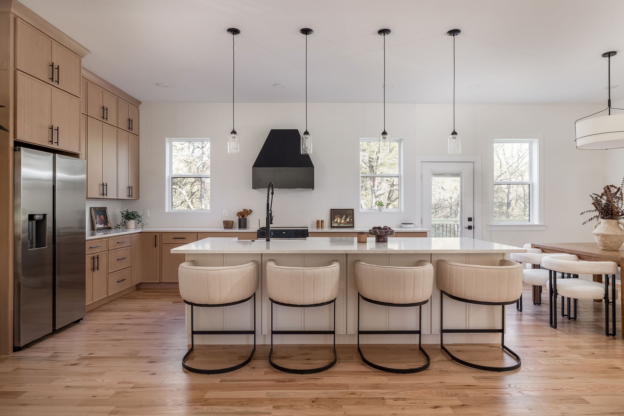 An immaculate OneToCrew design and build on a coveted street and pocket of Neelys Bend. Built from the foundation up, including an entire waterproofing of the basement level, this home can be your sanctuary for years to come. The open living area and kitchen allow for easy entertaining, featuring a large island perfect for congregating and ample storage, stainless steel appliances, floor to ceiling cabinets, and easy access to al fresco dining on the deck. The secondary bedrooms share the soaring ceilings on this floor and custom built closets. Extra living space can be found downstairs, with a large den and media area that walks out to the backyard. An additional two secondary bedrooms, bathroom, and laundry room allow this floor to potentially serve as a suite or room to spread out. The showstopper is the primary suite that encompasses the entire second floor, finished with cathedral ceilings, natural light, soaking tub, double shower, and matching double closets. Off of the bedroom is a flex room that can serve as an office, nursery, or yoga room. Namaste. Finish your workout and step across the hall to the private primary laundry, complete with a half bath. All of this, tucked on the magical river neighborhood on the bend. With almost an acre of green space, creek, and soaring old growth trees, this is the craftsman meets farmhouse you have been waiting on, just in time for the fall colors to grace the view outside your new soaking tub.