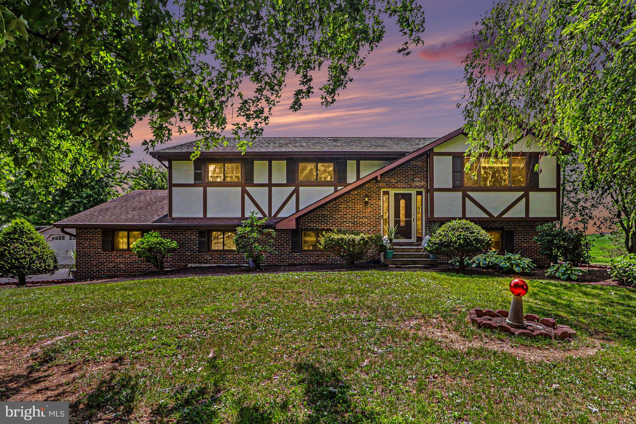 Here is your opportunity to own a beautiful, well maintained home situated on a picturesque 4  acres. With plenty of room for kids and pets to play, this home is the perfect place to raise a family!The home has been thoughtfully updated over the years, starting with the kitchen, which features high-end custom Snitz Creek cabinetry, granite countertops, recessed lighting, a propane cooktop, and a convection wall oven and microwave. The kitchen opens seamlessly into the dining room—which is large enough for holiday gatherings—and the living room. Throughout the main level, large windows offer exquisite, expansive views of the surrounding land. The primary bedroom is generously sized and includes a walk-in closet and a full en-suite bathroom.The lower level offers a fourth bedroom, currently used as a craft room, but it could also serve as an excellent home office. This level also features a half-bath and laundry room combo, as well as an expansive family room with enough space for a pool or ping-pong table. Off the family room is an amazing three-season room that provides a relaxing space to read and take in the backyard views.Outside, the back patio is perfect for entertaining and features a large hot tub, a patio area and an adjacent pond and water feature. The house also has an oversized, finished two-car garage with an epoxy floor, storage closets, and room for workbenches, plus a convenient side door to the yard. There is ample parking, including a dedicated spot for an RV, and multiple sheds for additional storage.Recent updates include fresh paint in most rooms, updated upstairs bathrooms, and newer engineered hardwood flooring throughout most of the home.This property has been meticulously maintained by its original owners, and true pride of ownership shows throughout.