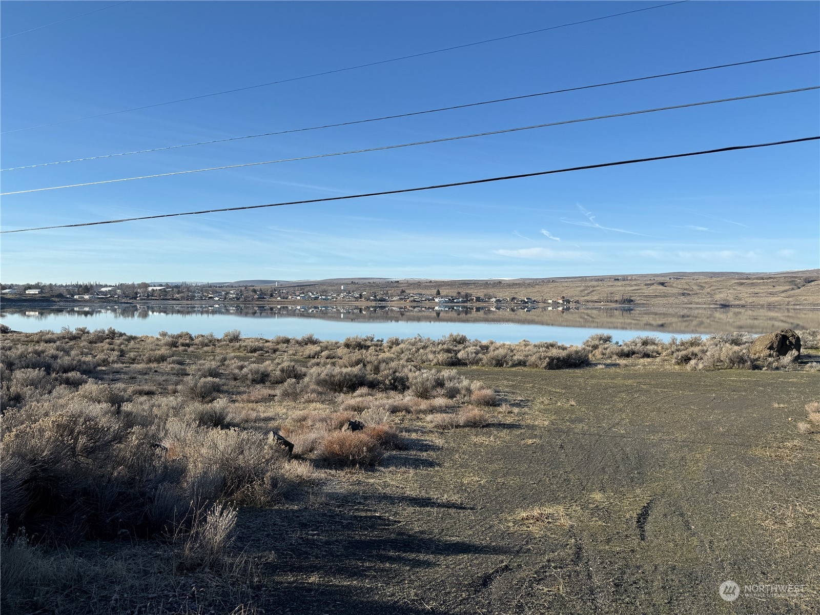 Level, irregular shaped lot comprised of a total of 4.53 acres on Soap Lake.  Approximately 1,000 feet of high bank waterfront.  In city limits, zoned R1. Survey completed in 2023.  Buyer’s responsibility confirm zoning requirement and to connect to all city services and electricity.