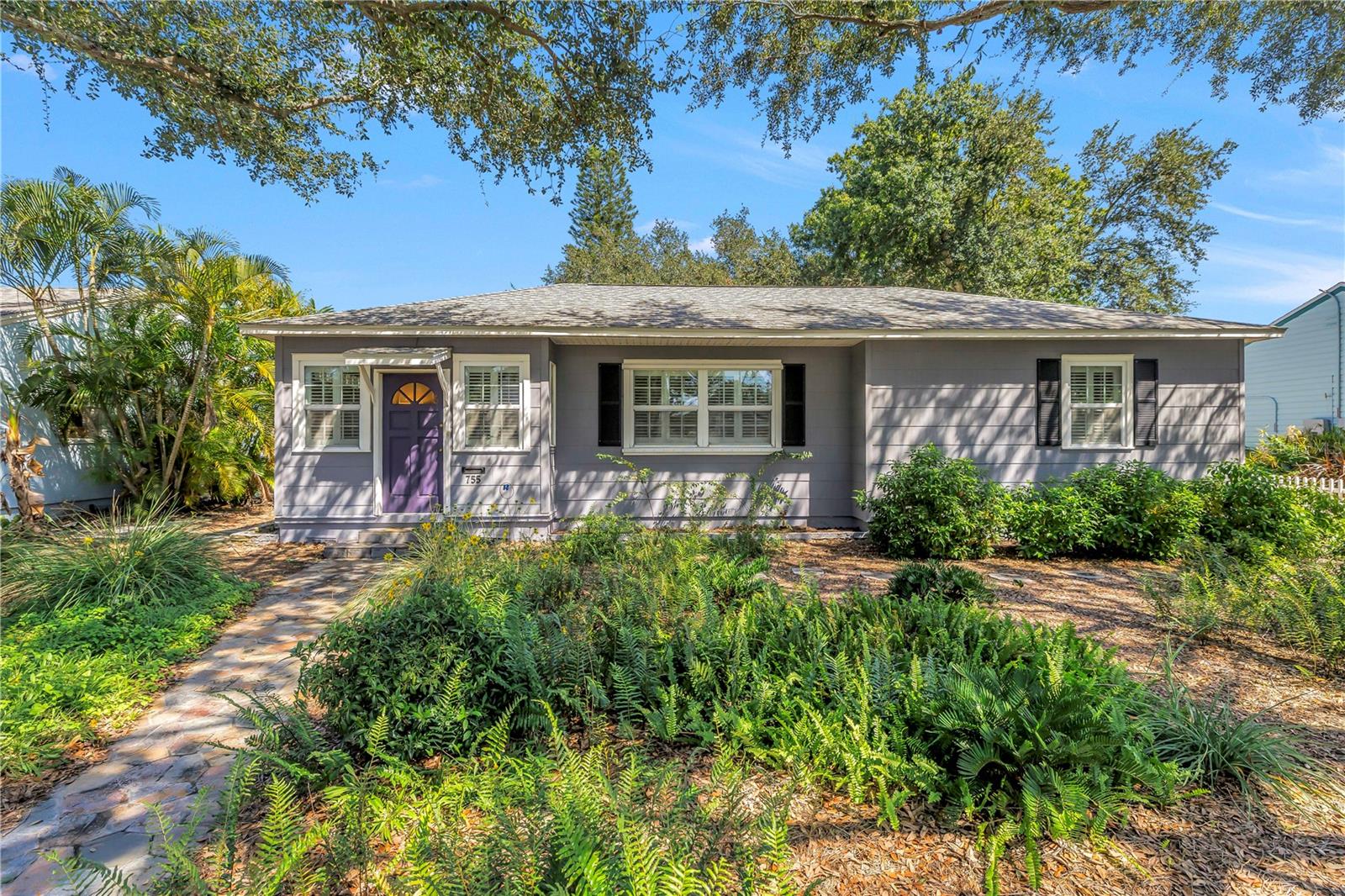 Welcome to a beautifully updated bungalow in Northeast Park Shores where thoughtful design, effortless comfort, and indoor-outdoor living come together. This charming 2-bedroom, 1-bath home may be intimate in size, but it lives remarkably large, offering a smart and inviting layout designed to make the most of every square foot. Step inside to a refreshed interior with a warm, polished feel and an easy flow that makes everyday living and entertaining feel effortless. Enter into an expansive dining room, with a tongue-and-groove wood ceiling, tile floors, and natural light. The living room features hardwood floors, window shutters and original archways between rooms. As you continue on, a small alcove leads to the bedrooms and full bath, which was thoughtfully updated with a walk in shower and large vanity. The kitchen features custom two tone cabinetry, quartz countertops, gas range, and stainless steel appliances. The entertaining experience continues outdoors with a breezy screened porch that opens to the large, fully fenced backyard that truly expands the living space. Whether you're hosting a casual dinner, enjoying morning coffee, gathering around for drinks, or creating your own private outdoor retreat, this generous yard provides exceptional flexibility. At its heart, a mature oak tree adds beauty, shade, and a timeless sense of character to the property. An oversized one-car garage adds valuable convenience and storage, complete with laundry, and the rear driveway provides parking for multiple cars and recreational vehicles. With its combination of updated interiors, charming bungalow character, and an outdoor space that feels surprisingly expansive, this property offers a lifestyle that is both stylish and easy to enjoy.