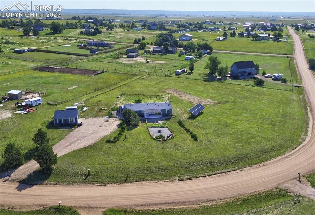 Just 15 minutes East of the rapidly growing Falcon you'll find this ranch home on 2.5 acres in the Blue Sage neighborhood of horse properties that include miles of riding easements.  Unlike many homes in the area, this home sits on a gentle slope that provides you direct views of Pikes Peak and panoramic views of the Front Range right from your porch.  There are some nice finishes inside, like a kitchen with tons of cabinet and counter space, durable laminate flooring in the main living areas, a brick-accented reading nook in the great room, a master suite with a walk-in closet and private 5-piece bathroom, and some updated accent lighting.  Outside you'll enjoy an over-sized 2-car garage/shop with some extra storage sheds on the property.  A section of the 2.5 acres is fenced to contain animals or kids, and there's a solar panel system that's included with no payments or lease--just "free" electricity from the sun.  This home is the best value for the features and is waiting for you and yours to start enjoying life on the plains in sight of the Rocky Mountains, just like you've always wanted.