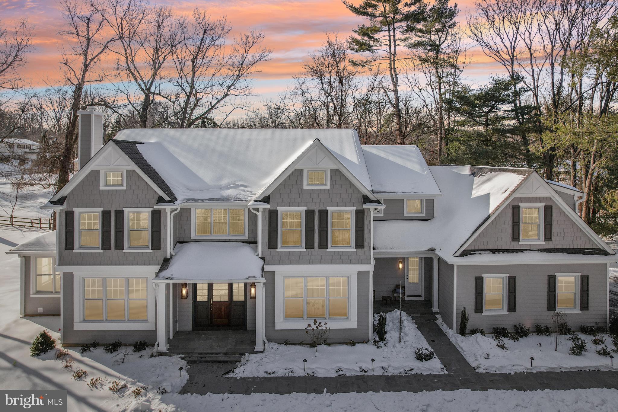 Construction is complete on this Custom new home by one of the Main Line's most respected custom home builders, John Rayer & Son Builders. This stately 5-bedroom, 6-bathroom residence is a masterful blending of classic style and state-of-the-art design. The home seamlessly combines storied architectural detail with the cutting-edge features and finishes expected by today's discerning buyer. With its long drive way, and on a completely private, fully landscaped lot with irrigation system and landscape lighting, the property offers a serene oasis in a popular Lower Merion neighborhood. The elegant custom design extends from the natural Pennsylvania flagstone walkway and solid mahogany front door to the oversized rear patio. The interior of the home is a testament to quality craftsmanship. Elevated features include 8-inch-wide plank natural white oak flooring, custom crown molding and paneling and solid white oak railings. The floor plan impresses with ample formal and casual spaces, front and back staircases, two powder rooms on the first floor, huge kitchen/great room and a large mudroom with built-in cubbies. The Gourmet Chef's Kitchen is equipped with top-of-the-line Thermador appliances, including a 48” range, double steam wall ovens, two sinks and more. Two fireplaces with stone surrounds adorn both the family and living rooms. The home features an eye catching professional wine cellar, appointed with a slate floor and cedar shelving, and maintained by a top-of-the-line WhisperKool cooling system; it sits just off the dining room on the main level. The luxurious Primary Suite is a spacious retreat with a massive custom closet by Topshelf Closets and a spa-like primary bath featuring Carrara marble floors and Brizo plumbing fixtures.  The huge lower level has 9-foot ceilings and provides an additional 2,294 sq ft of space that could be customized to meet many needs.  This property is located in the top-rated Lower Merion School District just a 20-minute commute to Center City Philadelphia and leaves nothing to be desired.