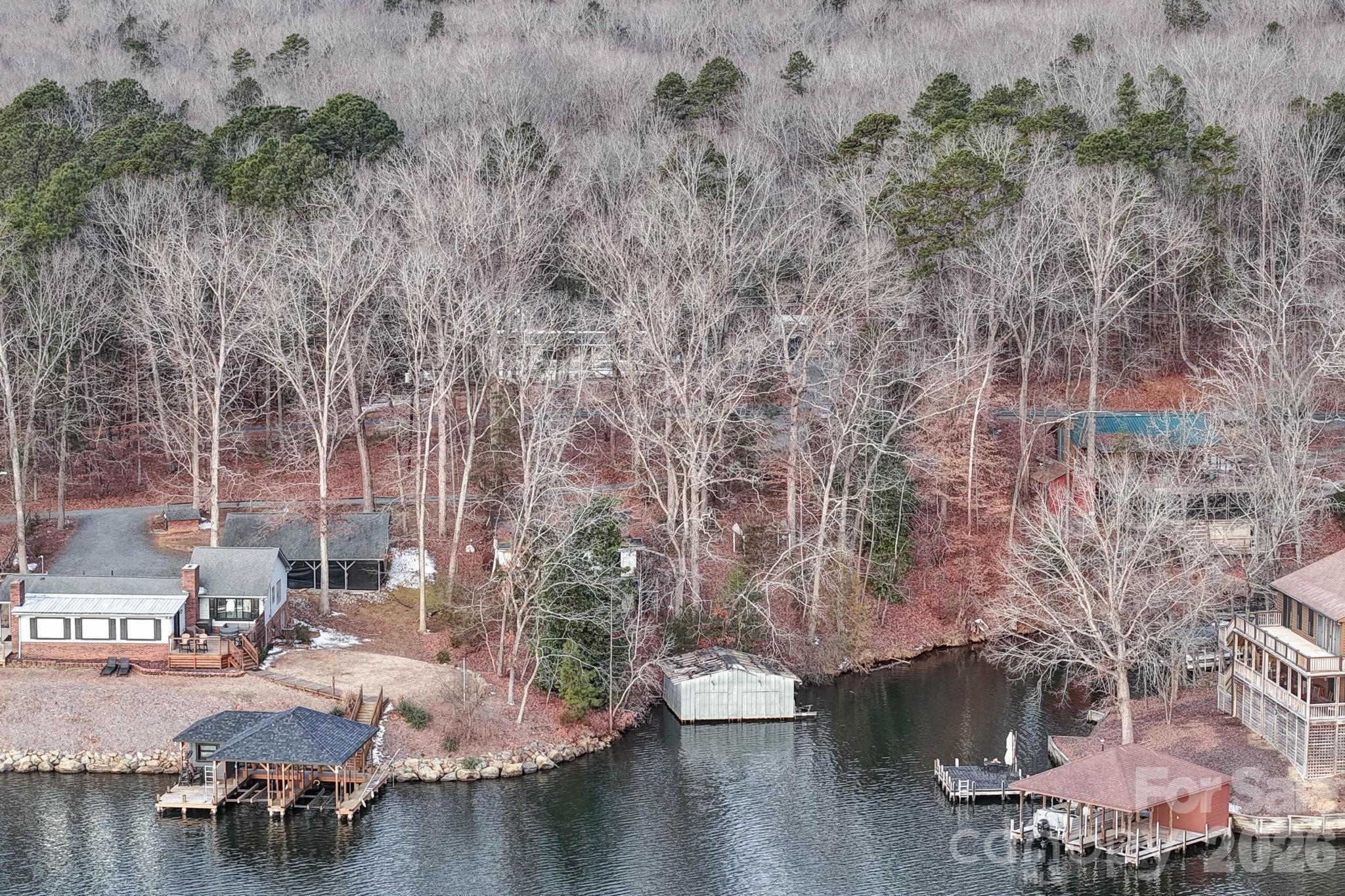 Rare opportunity on Lake Tillery featuring three combined lots across two parcels with an existing old home place and dock on the main channel. Property offers main channel lake views and multiple possibilities for future use.The existing home and dock have not been occupied or maintained in many years and are in poor condition. Structures are considered in need of significant repair or removal. Buyer may choose to rehab/build onto the existing structure or remove and build new, subject to county and lake authority approvals.County water is available but has not been tapped into. Septic system is installed; condition is unknown.Extreme caution is advised if entering the home. Total acreage is approximately 0.34 acres (combined lots). Tax value and lot size reflect the total property. Property is being sold as-is. Ideal for buyers seeking a lakefront building opportunity with main channel exposure. No HOA.