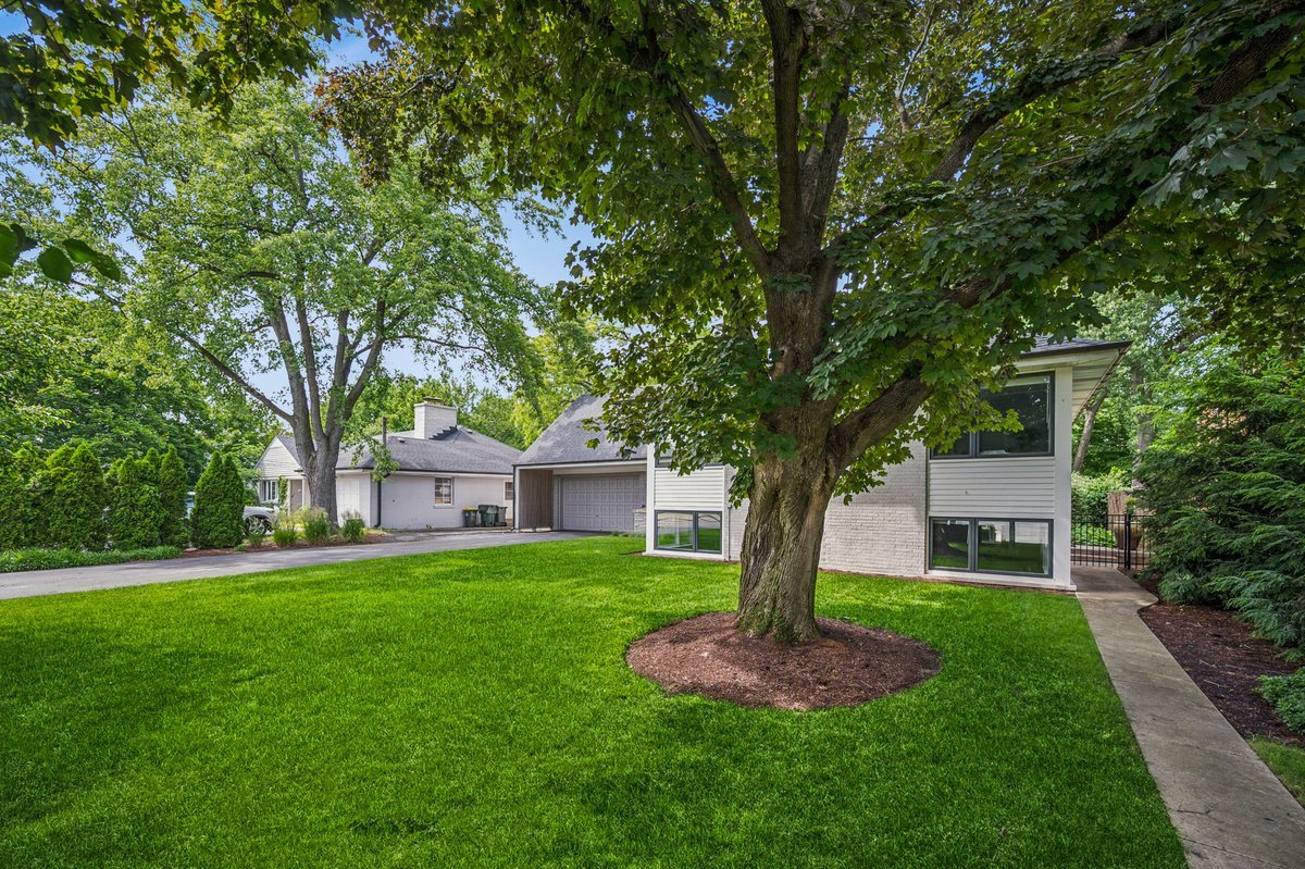 Privately tucked on an extra wide 1/3rd acre property, this fully re-imagined mid-century modern home offers exceptional design and incredible vistas of its lushly landscaped property.  Thoughtfully curated with attention to detail and a sophisticated eye for design, the home blends timeless architecture with abundant natural beauty, right in the heart of Winnetka.  A super chic, modern kitchen with abundant custom cabinetry and top-tier appliances is anchored by a large island and opens to a stunning dining room with radiant-heated floors and walls of windows beautifully framing panoramic views of the verdant property. The stylized mid-century living room features a contemporary gas fireplace and overlooks the professionally landscaped grounds, perennial gardens, and brick patio. The inviting family room, complete with radiant-heated floors and a second fireplace, offers a warm and stylish gathering place. The luxurious primary suite is a true sanctuary, featuring a private sitting room with built-ins, custom closets, and a spa-inspired bath. Three additional generously sized bedrooms - one ensuite and two sharing a hall bath - provide beautifully appointed modern accommodations for family and guests. The large rec room offers plenty of space for lounging, a work-out area and/or game area, plus a separate laundry room and access to the attached and heated 2-car garage.    Every detail of this home has been thoughtfully re-imagined to create effortless indoor-outdoor living. Enjoy an intentional, design-forward home surrounded by beautiful grounds with blooming gardens, and located within easy walking distance to town, schools, parks, the A.C. Nielsen Tennis Center, the Winnetka Golf Club, and the Skokie Lagoons.