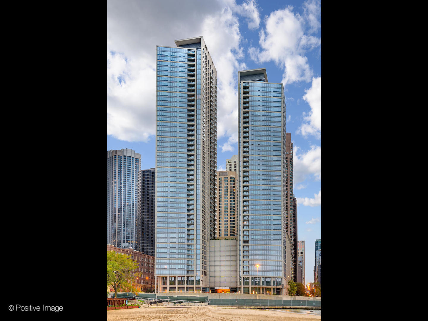 Come tour this high-floor two-bed, two-bath corner unit located in the heart of Streeterville.  Upon entering, you'll be greeted by hardwood floors and a functional split floor plan.  Enjoy the convenience of a private balcony where you can get fresh air and take in the city views. Benefit from a seamless flow for entertaining, living, dining, and relaxing.  The kitchen boasts granite counters, stainless steel appliances, and inviting bar seating. Utilize the versatility of the residence and add a table to create a dedicated dining space. Retreat to the spacious primary suite, featuring a  walk-in closet that effortlessly accommodates your belongings.  Ample storage space throughout (+ storage cage) helps provide a clutter-free living experience, while the unit's washer/dryer adds an extra layer of convenience.  Indulge in the tranquility of the spa-like primary bath, complete with a walk-in shower, soaking tub, and double vanity.  Cater to your needs with a second bedroom which can easily be a full-time bedroom or office.  Two parking spaces are available for purchase for 35K/space along with unit. Live a life of luxury in this full amenity building, where your needs are catered to by five-star service and on-site management/maintenance.  Enjoy peace of mind provided by the 24-hour door staff, take advantage of the on-site business center, and stay fit in the well-equipped fitness center or take your wheels out from the bike room and hit the lakefront path.  Immerse yourself in breathtaking views from two rooftop terraces (+10th floor terrace), equipped with grills and fire pits, and community rooms perfect for hosting guests.      Located just steps away from the lake, beach, parks, Navy Pier, renowned restaurants, entertainment venues, shopping, and Northwestern University, this perfectly positioned condo offers a truly unparalleled lifestyle. Schedule a showing now!