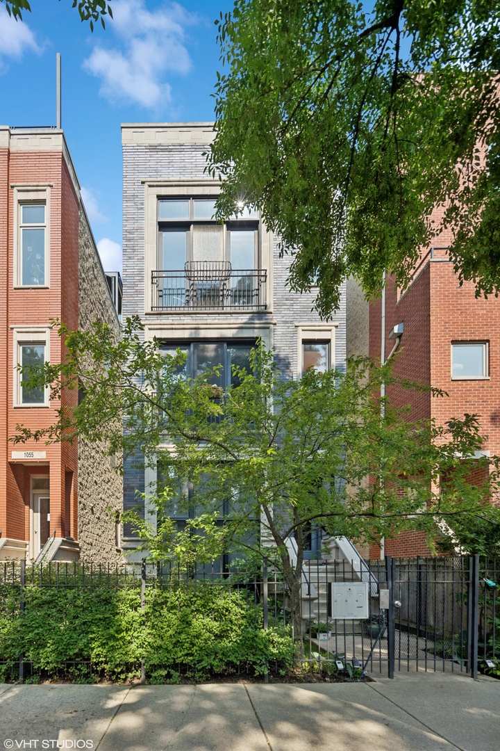 Sun-drenched and stylish, this beautifully updated 2 bed / 2 bath penthouse is the perfect blend of indoor comfort and outdoor luxury, nestled in the heart of Wicker Park/East Village. With two private outdoor spaces including a spacious main level terrace and an expansive rooftop deck with skyline views this home truly has it all. Enter through your private interior staircase into an airy, open-concept layout with soaring ceilings, oversized windows, and rich hardwood floors throughout. The wide living and dining area is ideal for entertaining, featuring a cozy wood-burning fireplace and built-in wine fridge. The modern kitchen is sure to impress with sleek white cabinetry, sleek black granite countertops, breakfast bar seating for four, and stainless steel appliances. The king-sized primary suite includes custom closets and access to a private terrace, with a luxurious en-suite bath featuring dual vanities, a jetted tub, and a separate shower with body sprays. The second bedroom is generously sized with easy access to a stylish second full bath.Head upstairs to your private rooftop oasis, complete with panoramic city views, multiple lounging and dining areas, and an outdoor speaker system, perfect for entertaining or relaxing. Additional features include in-unit laundry, an oversized storage unit, and garage parking. All this on a quiet, tree-lined street where Wicker Park meets East Village, just steps to Division Street, the Blue Line, top-rated restaurants, boutiques, parks, and nightlife. Easy expressway access and located in the highly sought-after Pritzker Elementary School District. A true gem in one of Chicago's most vibrant neighborhoods, this one checks every box. Don't miss it!