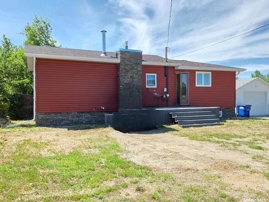 Wymark might not be on everyone’s radar, but that’s exactly what makes it special—quieter than Mayberry, smaller than Dog River, and only 15 minutes from Swift Current, this little prairie community packs a lot of charm into a tight-knit package. And if you’re looking for a home that’s both family-friendly and move-in ready, this bungalow at 214 Flora Avenue, right across from the K-9 school, ticks all the right boxes. In 2014, it got a major refresh with new siding, windows, soffit, fascia, and eaves—so the big stuff’s already taken care of. Inside, the main bathroom is impressively spacious and dressed to impress with ceramic tile finishes. The kitchen and dining area are open and airy, perfect for weeknight dinners or weekend brunches, and they wrap around into the cozy living room, complete with a wood-burning fireplace that makes chilly evenings something to look forward to. Step through the patio doors in the dining area and you’ll find a west-facing deck ideal for catching Saskatchewan sunsets, plus a large, fenced backyard that’s perfect for kids, pets, or your dream garden. There's even a charming, elevated playhouse that will keep little ones entertained for hours. Downstairs, the fully finished basement adds a ton of livable space with a roomy rec room, three bedrooms, and a convenient combo laundry/2-piece bathroom. Whether you're a growing family, a first-time buyer, or someone craving small-town vibes without sacrificing city access, this home delivers. Curious? You know what to do—call your friendly neighbourhood real estate agent and come see it for yourself.  Heat equalized at $85/mo/11mos