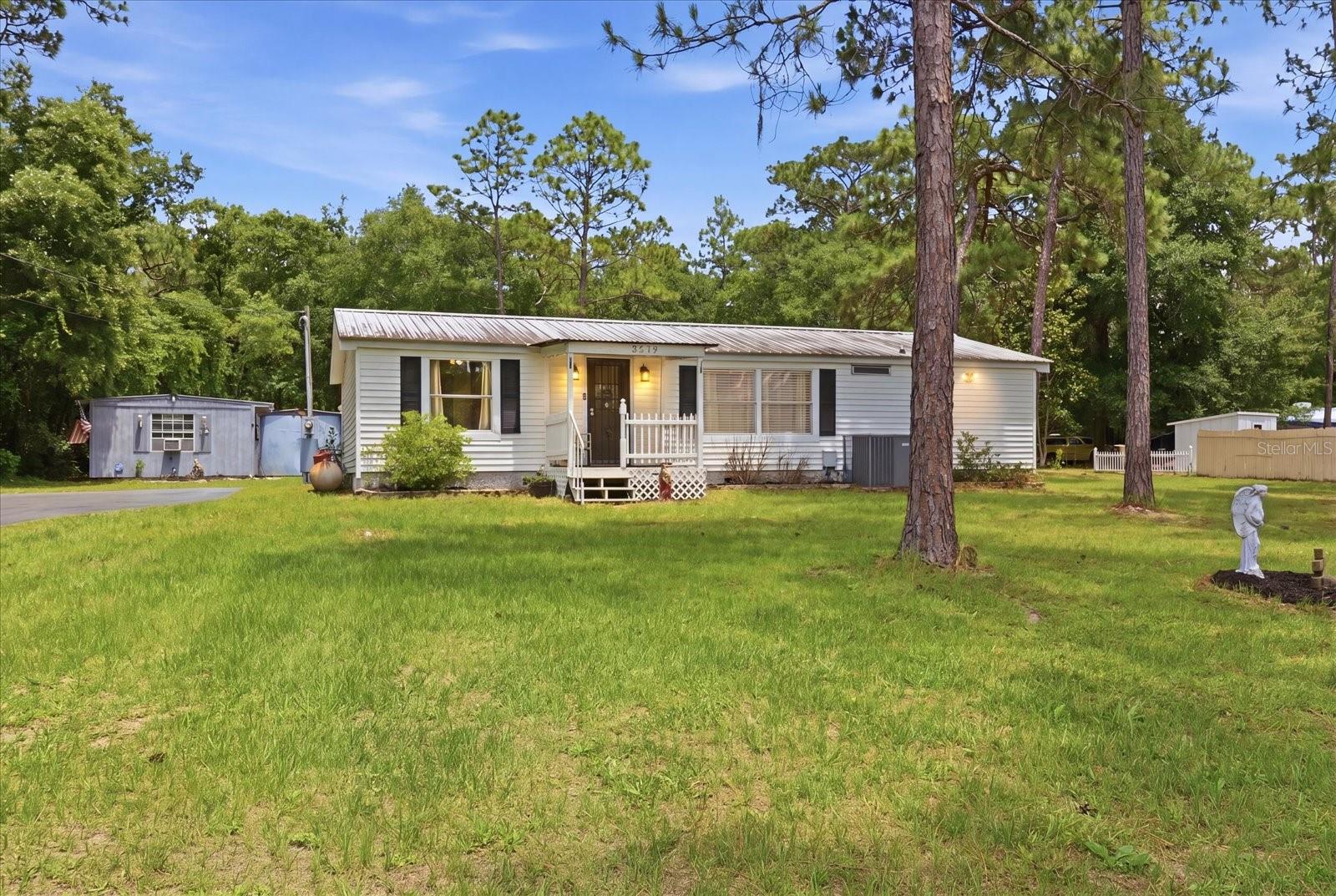 Homosassa retreat! Tucked away from the road and bustle of the city quaintly sits three bed and two bath home on over a half acre. Maintained over time with updates such as a 2016 all metal roof and an HVAC system from 2018. The home offers a split floor plan with vinyl plank flooring through out and cathedral ceilings to bring a spacious feel. Kitchen updates include granite counters, wooden cabinetry, and stainless appliances. Home-cooked meals on the propane oven served in your designated dining room. Two bedrooms and one bathroom on one side of the home while your owner's suite sits on the opposite. Adding even more functionality we have our indoor utility room towards the back of the home. Enjoy scenery of the nature coast with your enclosed back porch with all glass windows offering the option to keep it cool while keeping the views! Make your way out back to your metal building shop equipped with concrete slab floor, roll up garage door, and raised ceilings. Additional storage attached with the once proclaimed boat house and beyond that sits the bonified man-cave. A makeshift place to escape and host those poker nights, football games, or maybe even just another option for storage. This home has been maintained with care and character throughout and is truly ready to be appreciated by it's next owners. Schedule your tour today.
