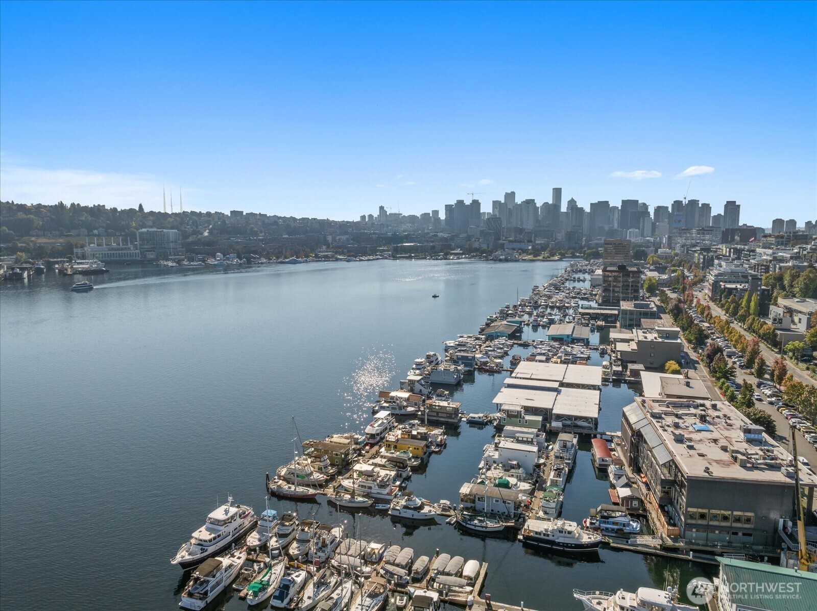 Welcome to Cubana! Completely-remodeled fully-furnished houseboat w/ every amenity & loads of natural light. All decks resurfaced recently. Enter to a lofted seating area w/ Lake & City views leading to the fully-updated kitchen w/ dining space & cozy fireplace. New efficient appliances, countertops & flooring. Bright bedroom includes new ensuite laundry & full bath w/ tasteful marble-finish & soaking tub. Plenty of outdoor space--2 lower decks & a full roof deck, all new fiberglass w/ wide views of Lake Union, Gasworks & Downtown. BG Trail outside your door takes you to 7 neighborhoods as well as many large employers. Moorage includes W/G. Easy parking. Hauled-out & bottom-painted recently. Pets & Rentals allowed, FOWR 715