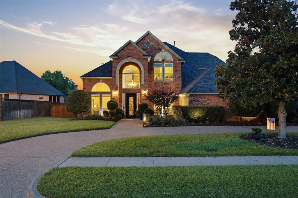 MULTIPLE OFFERS RECEIVED - Nestled in the highly sought-after neighborhood of Mill Creek in the heart of Colleyville, this beautifully maintained custom home offers flexible open layout with 4 bedrooms, 3 baths, and 3 living areas with spacious living throughout.  Beautiful engineered wood floors lead you past the formal living room, dining room and spiral staircase into main living area. The main living room is the centerpiece: soaring ceilings, a dramatic two-story brick fireplace, wet bar with refrigerated wine storage and towering windows offering sweeping views of the backyard oasis. Natural light pours in, highlighting the seamless flow into the gourmet kitchen—complete with a generous island and cabinet storage, breakfast bar, double ovens, and a breakfast nook. Entertaining and family time feel effortless in this family flexible open-concept layout. The main-floor primary suite is a restful retreat with vaulted ceilings, bay window seating area overlooking the pool, and a spa-style bath featuring a garden tub and a separate shower—an ideal private haven. Upstairs functions as a true kids’ wing: two oversized bedrooms with vaulted ceilings share a Jack-and-Jill bathroom and game room—perfect for study and play. Outside, an oversized private backyard is built for living: ample lush lawn for pets and play, a sparkling pool with attached hot tub, and an expansive covered patio with a built-in Blackstone for alfresco dining and long summer evenings. Additional features include electric driveway gate, circle drive, and a three-car garage with a Versa Lift storage system for easy organization and attic access. Location is exceptional, minutes from DFW Airport, close to premier shopping and dining, top-rated schools, and just a short walk to the Colleyville Nature Center. This Mill Creek home blends thoughtful upgrades, abundant space, and outdoor luxury into a wonderful package. Experience the comfort of everyday living paired with the ease of entertaining.
