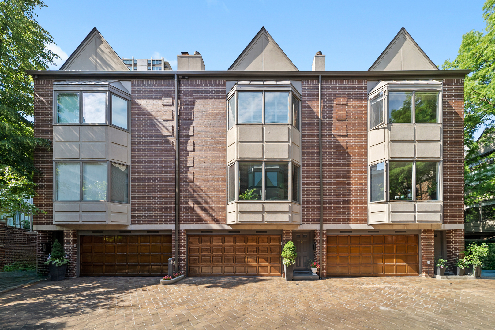 Nestled in one of Chicago's most sought-after gated communities-Beekman Place-this spacious 3-bedroom, 3.1-bath, three-story townhome offers nearly 3,000 square feet of refined living space, combining luxury and convenience in the heart of the Gold Coast. The sun-filled living room, complete with a cozy gas fireplace, flows seamlessly into the open dining area and an eat-in kitchen featuring custom cabinetry, granite countertops, and stainless steel appliances. A powder room is also conveniently located on the main level. The spacious primary suite boasts vaulted ceilings, two walk-in closets, and a luxurious ensuite bath with dual sinks, a soaking tub, and a separate shower. Two additional bedrooms and a full bath provide ample space for guests.  The lower-level family room is ideal for entertaining, offering a full bathroom, beverage cooler, and direct access to a private 500 sq ft patio-one of the largest in the complex and positioned at the rear of the home for added privacy. Additional highlights include hardwood floors throughout, elegant crown molding and wainscoting, a charming bay window, a new fence and garage door, ample storage, a new LG dishwasher and washer/dryer, and an attached two-car garage conveniently located within the complex-unlike other units with alley-access garages. Residents have the option to join The Sinclair's luxury health club and outdoor pool-just next door-for only $50/month. Just minutes from Michigan Avenue, Rush Street, Lake Michigan, Old Town, and Lincoln Park Zoo-and only a 10-minute walk to the beach-this home offers unbeatable access to the best of city living all located within the highly rated Ogden School District. Beekman Place also offers 24-hour doorman-secured entry in a private, gated community, providing a peaceful and secure living environment. This is truly a one-of-a-kind home in a hidden city oasis. Explore the property in 3D-click the 3D button to take a virtual tour and walk through every detail!