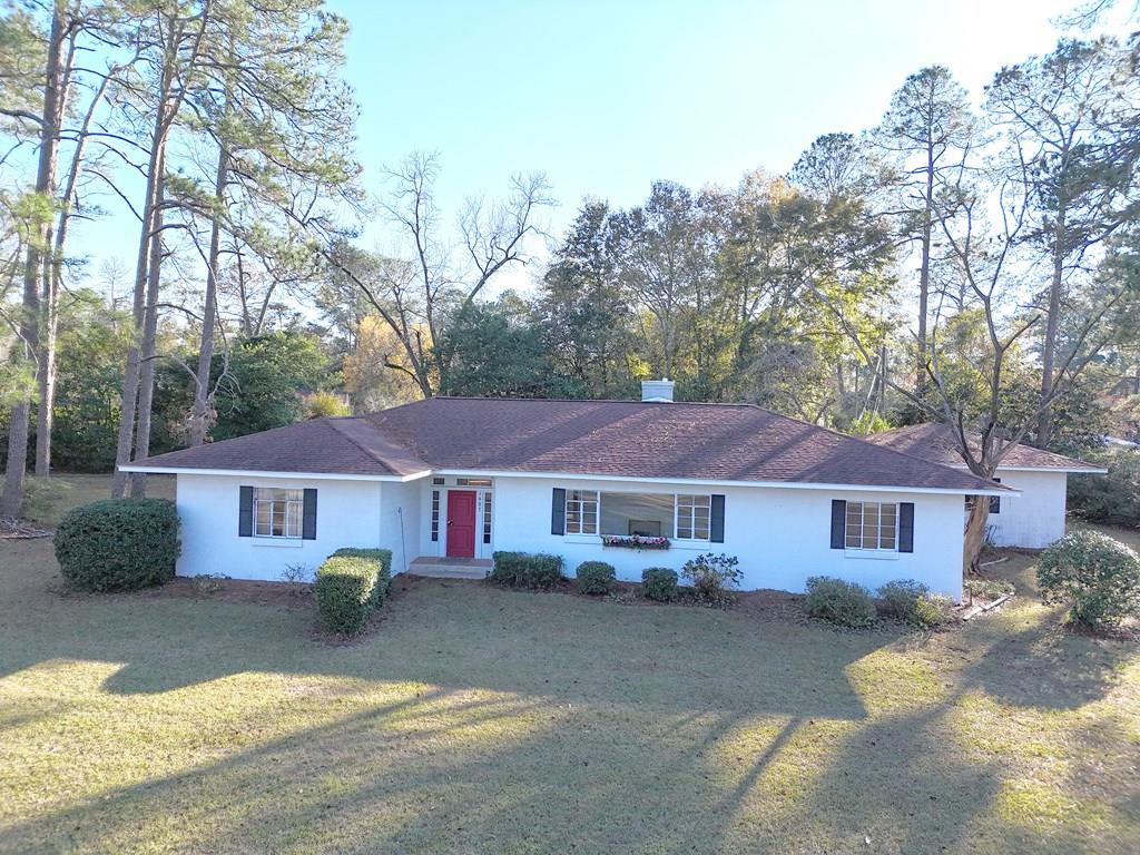 A true mid-century ranch with incredible space, style, and a spectacular setting you simply can't replicate today. Spanning over 3,000 square feet on a single level, this sprawling home delivers the kind of generous proportions and architectural confidence that defined an era—wide rooms, long sightlines, corner windows, and endless potential. At the heart of the home, a massive private back porch creates a show-stopping connection to the outdoors, overlooking a charming courtyard framed by black wrought iron fencing and gated for privacy. This home features rear-entry garage access that keeps the aesthetic clean and classic. Set on an oversized 1.51-acre lot, the property is wrapped in mature landscaping and offers plenty of room to expand, garden, entertain, or simply breathe. This home is a blank canvas for visionaries, as well as, ideal for those ready to restore, modernize, and elevate a true architectural gem. This beauty is ONLY 1.3 miles from Historic Downtown Cairo, GA, blending peaceful, private living with quick access to local shops, dining, and community charm. Big. Bold. Authentic. This is not just a typical Mid-Century renovation —it's a chance to create a one-of-a-kind, timeless statement showcase Home, with incredible character, scale, and super location.