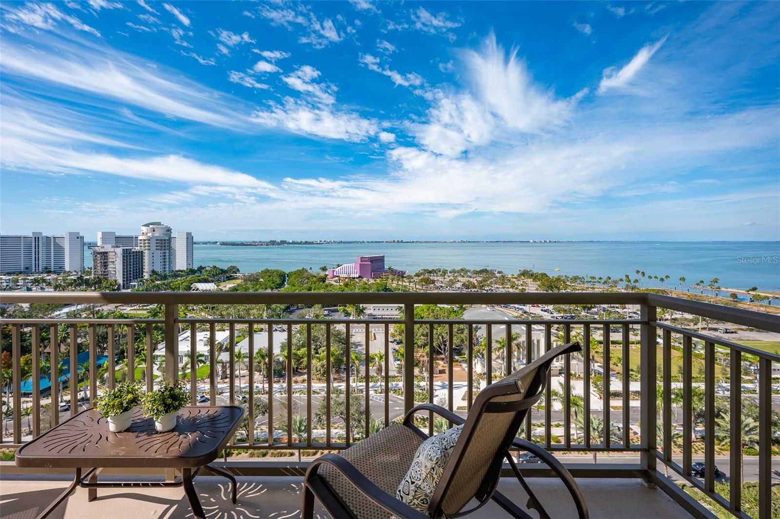 Immerse yourself with coastal luxury in this spectacularly designed two-bedroom, two-full-bath and one-half bath east to west corner unit in downtown Sarasota. Nearly every surface has been artistically modernized to provide supreme elegance, comfort and functionality. As you go inside, you will be immediately greeted by the bright interior, featuring 11-foot ceilings and open floor plan. The sunlight reflects beautifully off the porcelain tile throughout the unit and almost exudes the ambiance that you are walking among the clouds, although on the 15th floor. The beautiful flow of the porcelain tile, neutral palate and rich wood flooring in the primary bedroom elevate the look and make cleaning effortless. Every detail has been accounted for, and no expense has been spared when designing your future home. The kitchen's stately stainless steel appliance package, stone countertop, pantry and newly refinished kitchen cabinetry and hardware complement the overall atmosphere overlooking the vistas of Sarasota Bay turquoise water. Enjoy west and east balconies with breathtaking Sarasota Bay and city views. The primary en-suite bedroom has expansive views of the East sunrise large walk-in closet and secondary closet both with built-ins and a spa-like bath retreat. Your second bedroom is spacious with balcony access and closet with built-ins. There is a complete laundry closet between both bedrooms for convenience and complete with washer, dryer and storage shelving. There are beautiful lighting fixtures and fans throughout the residence. Living here means you will enjoy amazing sunsets on the west coast of Florida! When it comes to selecting your next building to call home, understand Alinari has all the amenities and security you would want in a Florida condominium building. Beyond the unit itself, Alinari offers a wealth of amenities. Residents of this stunning 18-story condominium high-rise enjoy lovely plazas, fountains and modern resort-style perks. The building is completely secure with key-card entry and 24-hour front desk services, including an overnight guard. The building is in flood zone X and outside the floodplain. Alinari is designed like a fortress and was constructed with reinforced concrete beams, has been fireproofed, and was built on pilings that were drilled deep into the ground for extra added stability and security. The lobby and guest parking spaces are elevated 17 feet above from the base sea level. This unit enjoys two assigned parking spaces (one on the third floor garage and one on the first-floor garage), which means your vehicles will be secured and elevated over 30 feet from sea level. From a grand entrance and an impressive lobby to concierge services, on-site management, secured parking, a clubroom, business center, fitness center and even a resident theater, every need is catered to. The location could not be better. In a contemporary-inspired building, Alinari is in the heart of Sarasota's cultural district. The opportunity to experience the epitome of downtown Sarasota living awaits.