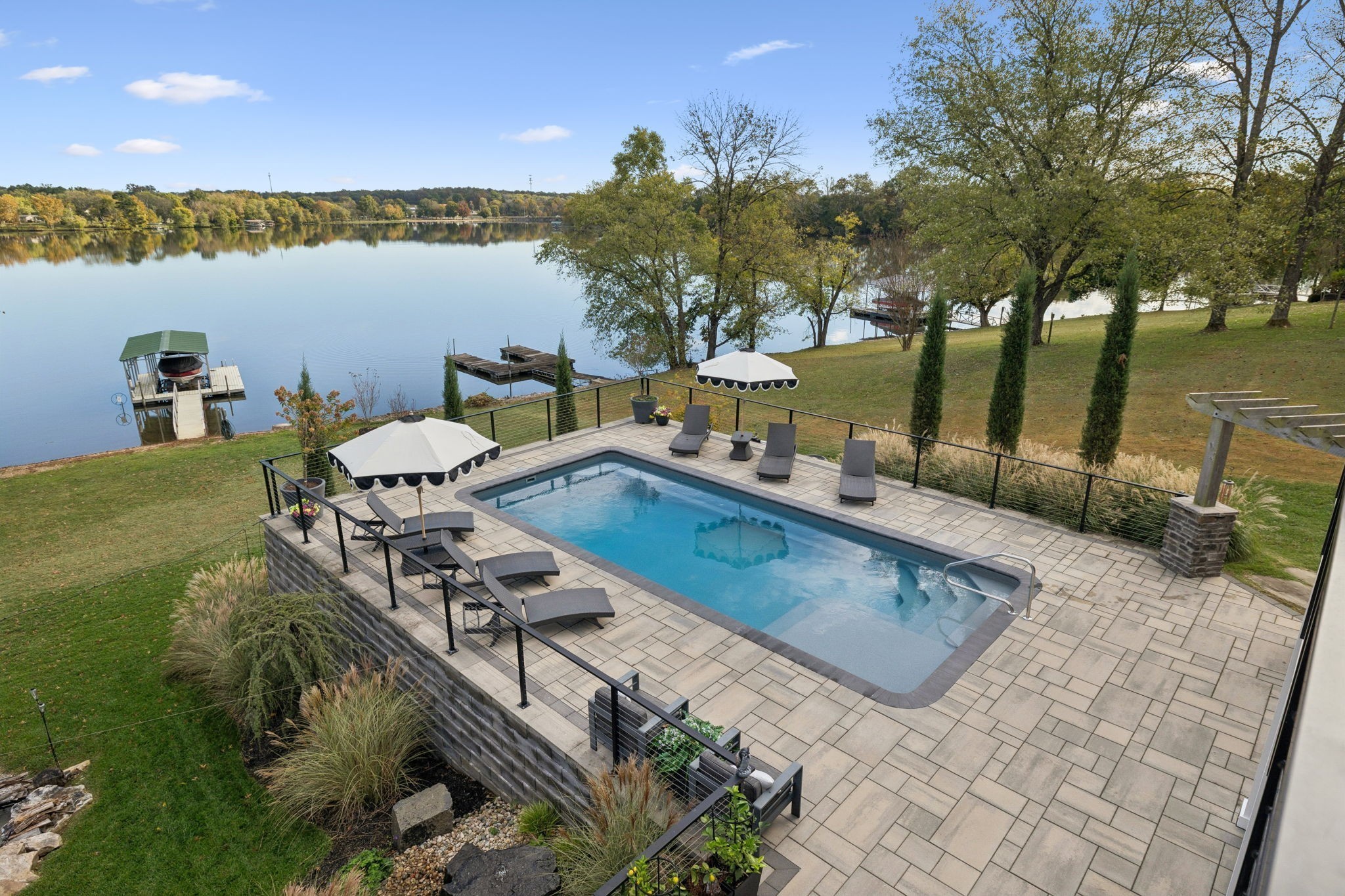 Exceptional lakefront estate on Old Hickory Lake offering refined luxury and effortless waterfront living. This remarkable home blends modern design with timeless serenity, showcasing sweeping lake views and true resort-style amenities. Outdoor living shines with a private dock, heated saltwater pool, fire pit, and expansive patio.Inside, designer finishes elevate every space. The show-stopping kitchen features quartz countertops, premium Thermador appliances, and double ovens, seamlessly connecting to the main living area where a marble fireplace and panoramic lake views create a stunning focal point. The primary suite is a private retreat with a spa-inspired bath complete with a soaking tub, glass-enclosed shower, and dual vanities. The fully finished basement is an entertainer’s dream, offering a gym, golf simulator, theater room, bar, wine room, and a custom dog spa. Thoughtfully designed and impeccably executed, this one-of-a-kind property delivers an unparalleled lakeside lifestyle. (Preferred lender is offering up to 1% of loan amount towards closing costs.)