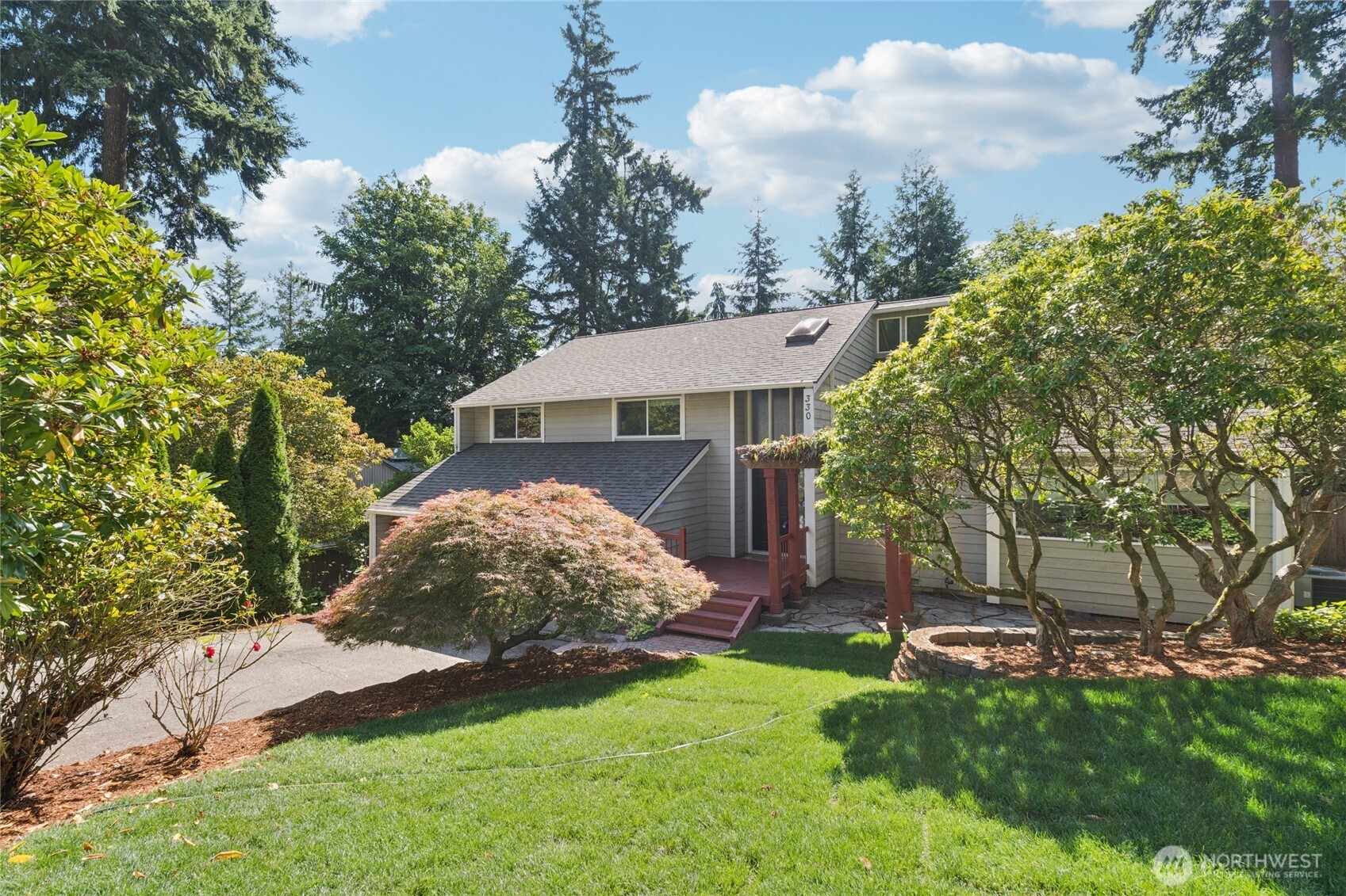 Tucked away on a quiet cul-de-sac in the sought-after Northshore School District, this 3-bed, 2.25-bath Bothell home offers 2,300 sq ft of stylish living. Soaring vaulted ceilings and a striking black brick fireplace set the stage in the spacious main living area, while the updated kitchen shines with granite counters and brand-new stainless steel appliances. The primary suite boasts two closets and a luxurious ensuite, and the rare mountain views add an extra touch of magic. Step outside to a multi-level deck perfect for summer gatherings, surrounded by a terraced garden and fully fenced yard. Modern upgrades include a 30-year comp roof and high-efficiency heat pump with A/C—comfort and charm in one package.