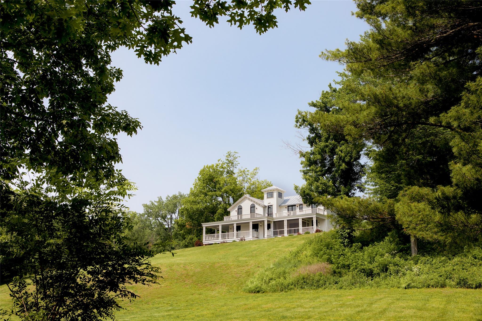 Ulster Landing is a storied & magnificent former Livingston estate established in the early 1800s, perched on 34 acres above the Hudson River with far-reaching views & more than half a mile of river frontage.
Down a long, winding driveway lies the historic and remarkably well-preserved main house.
On the 1st floor, the formal living & dining rooms have exquisite views of the river & are connected by the original arched doors. French doors line the living spaces, opening to the home's wraparound porch & overlooking the surrounding gardens & bluestone dining terrace. Inside, the deep berry-red kitchen was a painstaking collaboration between a local craftsman & the home's designer, with elaborate millwork, an AGA range, multiple restored historic pieces, & ample pantry & appliance storage.
The family room, office, library- complete with built-in bookshelves & a characterful indigo Antoinette Poisson wallpaper, and full bath/powder room completes the first floor.
The grand staircase twists around, meeting the second-floor landing & the best view in the house, framed by two large windows, the top of which disappears into the home's 'tower'. There are two distinct wings on the second floor - the owner's wing & the guest wing, each with its own staircase & landing.
The owner's wing is home to the primary suite & a kid's suite. The primary features vaulted ceilings & large arched French doors that lead out to a balcony. An expansive dressing room with built-in closets & a fireplace and primary bath with freestanding soaking tub facing the Hudson, & an alcoved toilet & shower complete the suite. Down the hall from the primary bedroom is the colorful kid's room with striped Swedish wallpaper & a walk-in closet. The two-toned kid's bath has a claw-foot tub with a shower surround. Second-floor laundry & a large linen closet complete the owner's wing.
A long balcony runs along the entire guest wing, offering access via French doors in the double guest suite & the single guest room. The double room features vaulted ceilings, an extra-large walk-in closet, & a full bath. The single room has detailed millwork & playful wallpaper, with its accompanying bathroom down the hall. 
The home is not short on functional yet tasteful utility spaces, with the ground-floor rooms converted into a laundry room, gardening mudroom, pantry & walk-in refrigerator, as well as significant storage space. The laundry & flower room is painted a deep ochre color, with ample built-in cabinetry, an XL utility sink, open shelving for vases, & two sets of high-capacity washers & dryers. The gardening mudroom has exposed historic brick walls & access to the surrounding herb & flower gardens, wood storage, & the exterior potting station.
Ulster Landing, with its 34+ acres, possesses a particularly dynamic landscape, with several rolling wildflower meadows, centuries-old flowering trees, winding walking trails, & a pebble beach along the Hudson River.
The heated gunite pool, spa, & surrounding bluestone terrace sit perched on top of a hill overlooking the river, with an outdoor shower & a concealed storage room built in below.
The circa 1800s barn, with a long bay currently acting as a garage, still contains much of the property's original maintenance & horse-drawn carriage equipment.
Up the driveway towards the property's entrance are the Playhouse & the Gatehouse. The Playhouse, a light-filled mid-century cabin, features a large living space, a kitchenette, a full bath, & a separate room that serves as a gym but could easily be used as a cousins' bunk room, art studio, office, or an overflow guest space. The Gatehouse is original to the property & is currently a charming one-bedroom cottage, ideal for caretakers, staff, or guests.
The home is minutes from Kingston's historic district, 15 minutes from Saugerties, Rhinebeck, Red Hook, Tivoli, & the Rhinecliff Amtrak train station, a half hour from Hudson, & just over an hour & a half from New York City.