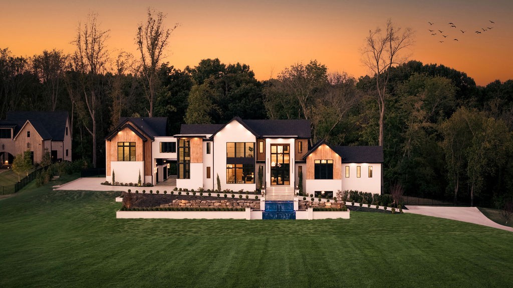 Introducing The Atrium, an extraordinary new-construction estate situated on over 2 gated acres in Brentwood's Bella Collina community, directly across from the prestigious Governors Club with unmatched breathtaking views of Williamson County. Encompassing 9,627 square feet, this architecturally striking residence blends exceptional craftsmanship, sophisticated design, and resort-inspired living.A dramatic arrival begins at the private gated entrance, where an architectural waterfall sets the tone. Inside, soaring 13-foot ceilings, 10-foot solid white oak doors, hand-scraped oak floors, and expansive walls of glass create an atmosphere of understated grandeur. A sculptural bent-wood staircase, custom brass accents, illuminated onyx, and an Arcus Stone fireplace showcase the home's distinctive character.At the heart of the residence, a stunning kitchen designed by Helen Hannah features custom white oak cabinetry, Taj Mahal quartzite, premium appliances, and a fully equipped scullery concealed behind a hidden door.The main-level primary suite offers a private retreat beneath a dramatic 23-foot vaulted ceiling, complete with custom European lighting, dual closets, and a spa-inspired bath featuring heated floors, Italian porcelain, illuminated onyx, a soaking tub, and private sauna.Designed for effortless entertaining, the outdoor spaces rival a private resort. A heated saltwater infinity pool with knife-edge design, zero-entry access, swim-up bar, and oversized spa anchors the grounds, complemented by an outdoor kitchen, covered entertaining areas, and separate guest residence.Additional highlights include a private cinema, glass pneumatic elevator, storm shelter, three laundry areas, and a four-car garage with capacity for eight vehicles using lifts.Thoughtfully designed to balance architectural beauty with everyday functionality, The Atrium presents a rare opportunity for elevated living just minutes from Cool Springs, Franklin, and Nashville.