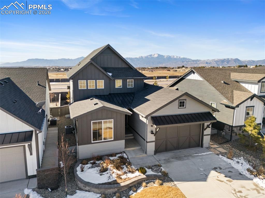 Experience luxury living in this stunning former Vantage Homes model, perfectly positioned to capture breathtaking, unobstructed views of Pikes Peak. Located in the highly sought-after School District 20, this meticulously crafted home offers a rare combination of designer finishes, functional elegance, and outdoor beauty. Step inside to soaring ceilings, expansive windows, and an open concept floor plan that fills the home with natural light and showcases the mountain vistas from nearly every room. Thoughtfully designed upgrades include gourmet kitchen appliances, quartz countertops, custom cabinetry, luxury plank flooring, and a spa inspired primary bath delivering both style and comfort. Entertain effortlessly in the spacious living and dining areas, or take the party outside to your fully landscaped backyard oasis. With a covered patio, professionally designed landscaping, full fencing and uninterrupted views, the outdoor space is an extension of the home’s high-end design. From top-rated schools and nearby trails to modern amenities and a vibrant community, this home offers not just a place to live but a Colorado lifestyle worth investing in. With the turnkey condition and model quality finishes, this is the one you’ve been waiting for.