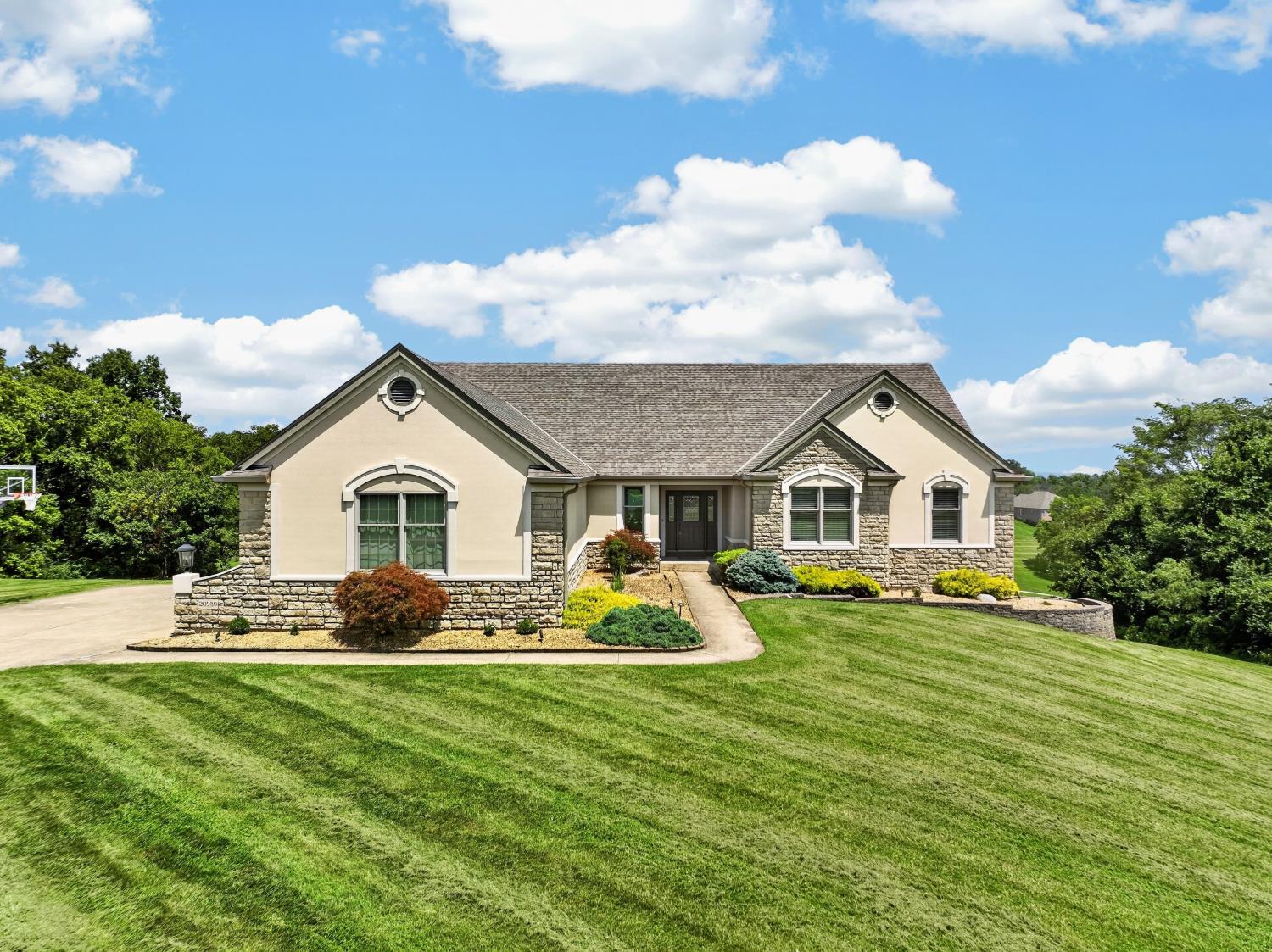 This beautiful custom transitional was designed to maximize exposure to wonderful golf course & valley views! Set back from the road, the home offers great privacy plus upgrades inside & out! Soaring vaults, decorative columns, hardwood & tile flooring, enormous custom kitchen w/ island & nook w/ 2-sided FP shared w/ sunken Great Room. Luxury Master suite has walkout to 2 lvl rear deck plus fabulous bath & custom walk-in closet. Three additional BR's on main level, plus laundry & 2 full baths. Finished walkout LL offers FR w/built-in theater area (included), corner wet bar, FP & space for games, all controlled by smart switches. Exercise room, full BA & 2 extra rms give great flexibility. Large unfinished storage/utility area connects to a built-in golf cart garage/workshop opening to the rear. An oversized 3-car garage w/ epoxy flooring houses vehicles with ease. Attractive landscaping, smart security system & more. Immaculate condition, great location! Extra lot available @ $149,900!