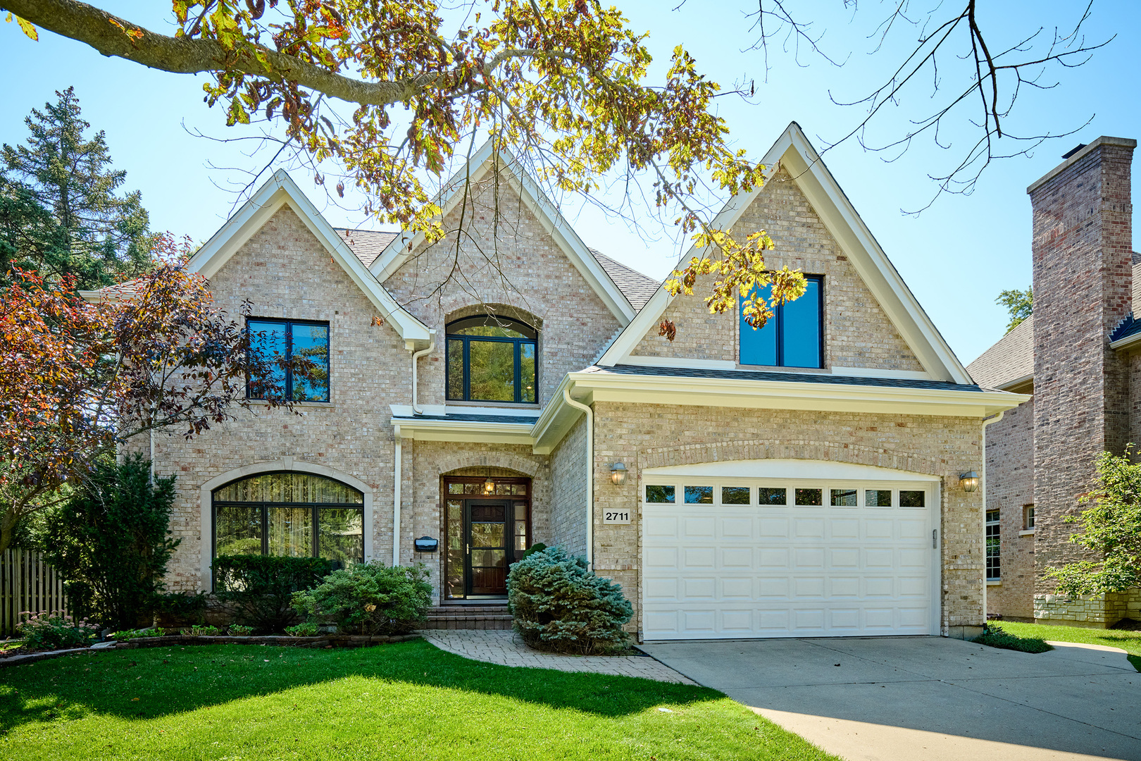 Timeless design, natural light, and incredible space come together at 2711 Orchard Ln,  a Drive-an exceptional Wilmette home in a truly coveted location tucked on a quiet, tree-lined block just steps to Community Park, award-winning schools-this brick and stone residence offers over 5,000 square feet across four thoughtfully finished levels. With 5 bedrooms, 4.1 baths, and refined architectural detail throughout, this home is move-in ready and built to elevate everyday living. Constructed in 2006 and maintained in pristine condition, the home welcomes you with soaring ceilings, gleaming hardwood floors, and custom millwork. At its heart is a sunlit family room anchored by a fireplace and framed by oversized windows-flowing seamlessly into the chef's kitchen, breakfast area, and deck perfect for coffee mornings or summer entertaining. custom cabinetry, and lush backyard views. Formal living and dining rooms offer elegant spaces for hosting, while the generous mudroom and heated 2-car garage (with extra-tall ceilings and built-in storage keep daily life organized and easy. Upstairs, the luxurious primary suite features tranquil, tree-filled views, a spa-inspired bath, and a walk-in closets. Three additional oversized bedrooms include a private en suite and a Jack-and-Jill pair, each with large closets. and the third floor offers flexible, finished space ideal for a playroom, guest area, creative studio, or teen hangout. The light-filled garden-level basement is a true extension of the home, with a large rec room, full bath, fitness room, and  a 5th bedroom. Outside, enjoy a fully fenced backyard with mature landscaping, ultimate privacy, and a spacious deck made for gathering. Located in the award-winning Wilmette/D39 and New Trier school districts, this home checks every box for style, function, and lifestyle, Recent updated include Dual Zone HAVC newly replaced in 2022 & 2025, Roof replaced in 2025, New Water Heater.