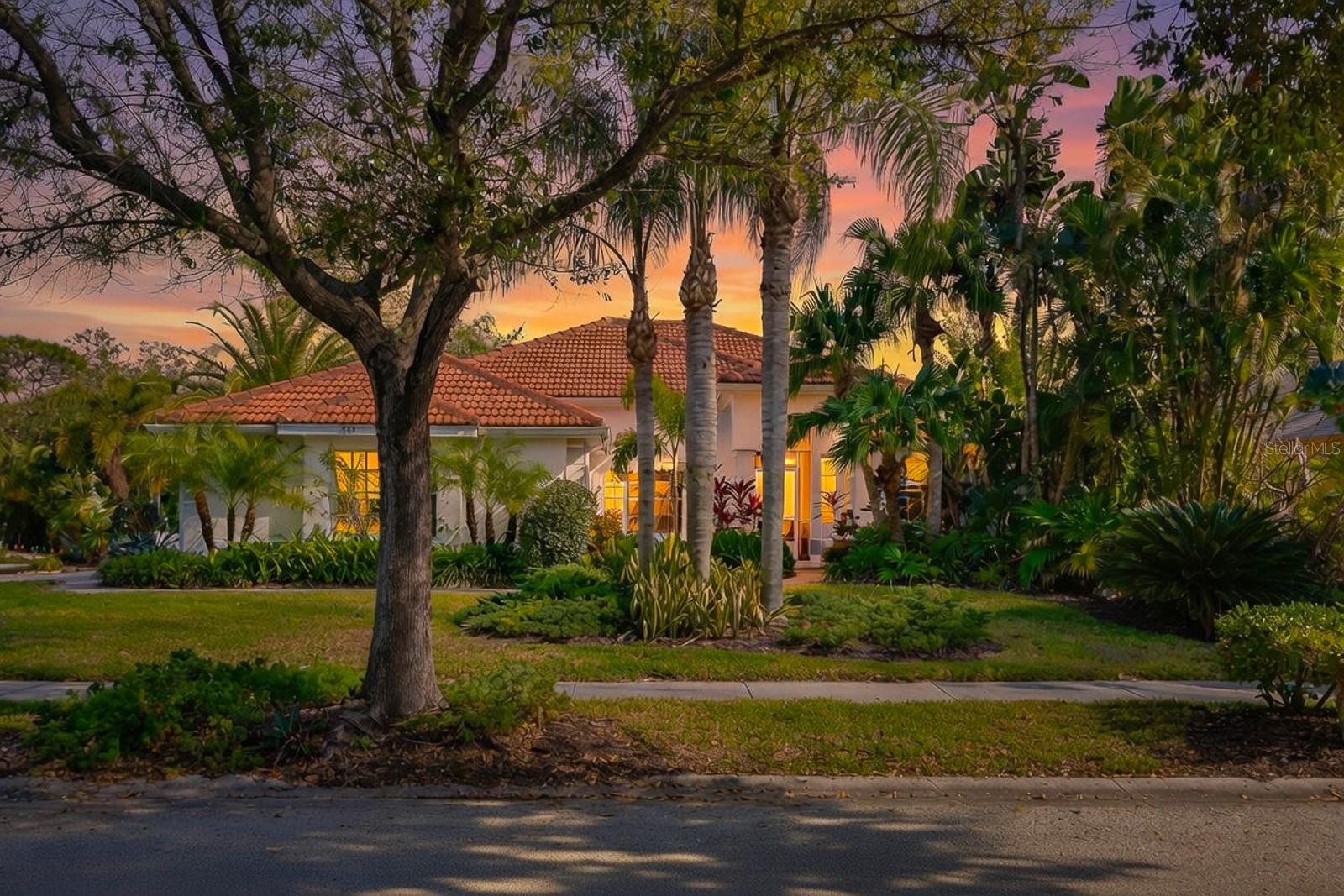 Welcome to this fully remodeled 4-bedroom, 2-bath modern luxury home perfectly positioned at the end of a quiet, dead-end cul-de-sac in Tarpon Springs. Offering 2,027 square feet of beautifully designed living space, this block-constructed residence combines high-end finishes, thoughtful functionality, and an exceptional coastal lifestyle—just minutes from Sunset Beach, Fred Howard Park, the Pinellas Trail, and the vibrant charm of downtown Tarpon Springs. Inside, vaulted ceilings and polished Petra Noir marble flooring throughout create a light, open, and sophisticated atmosphere. The heart of the home is the open-concept kitchen and family room, where a striking Italian porcelain, wood-burning fireplace anchors the space. Designed with both style and organization in mind, the chef’s kitchen features quartz countertops, a dramatic quartz waterfall island, high-gloss Italian-made cabinetry, a built-in pantry, custom drawer systems, lazy Susans for effortless access, Bosch stainless steel appliances, and a Franke sink and faucet—a true culinary showpiece built for efficiency and entertaining.Formal living and dining areas add flexibility, making the layout ideal for hosting gatherings or creating dedicated spaces for work or relaxation. The split-bedroom floor plan offers privacy, with three guest bedrooms and a Jack-and-Jill bathroom on one side of the home, and a private primary suite on the other. The ensuite bath delivers a spa-like experience with dual granite vanities, a marble-surround soaking tub, and Hansgrohe fixtures. Additional highlights include custom plantation shutters throughout, impact-rated sliding doors, energy-efficient low-E window film, a brand-new 2025 A/C system cooling both the home and garage, and a laundry room with new Electrolux washer and dryer. The air-conditioned 3-car garage is fully finished with epoxy flooring, screen doors, and a Bluetooth-enabled garage door opener, while a gas hookup is already in place for a future whole-house generator. Outdoors, enjoy a screened-in patio overlooking a private, lushly landscaped backyard oasis, surrounded by a wood fence for added privacy. There is ample room for a pool, with approved design renderings available from Premier Pool and Spa, making it easy to bring your dream outdoor retreat to life. Located on a very quiet street with highly rated nearby schools and a low annual HOA of just $550, this home is perfectly suited for a luxury downsizer or a family seeking modern comfort, privacy, and convenience. Schedule your private showing today—this exceptional home must be seen to be fully appreciated.