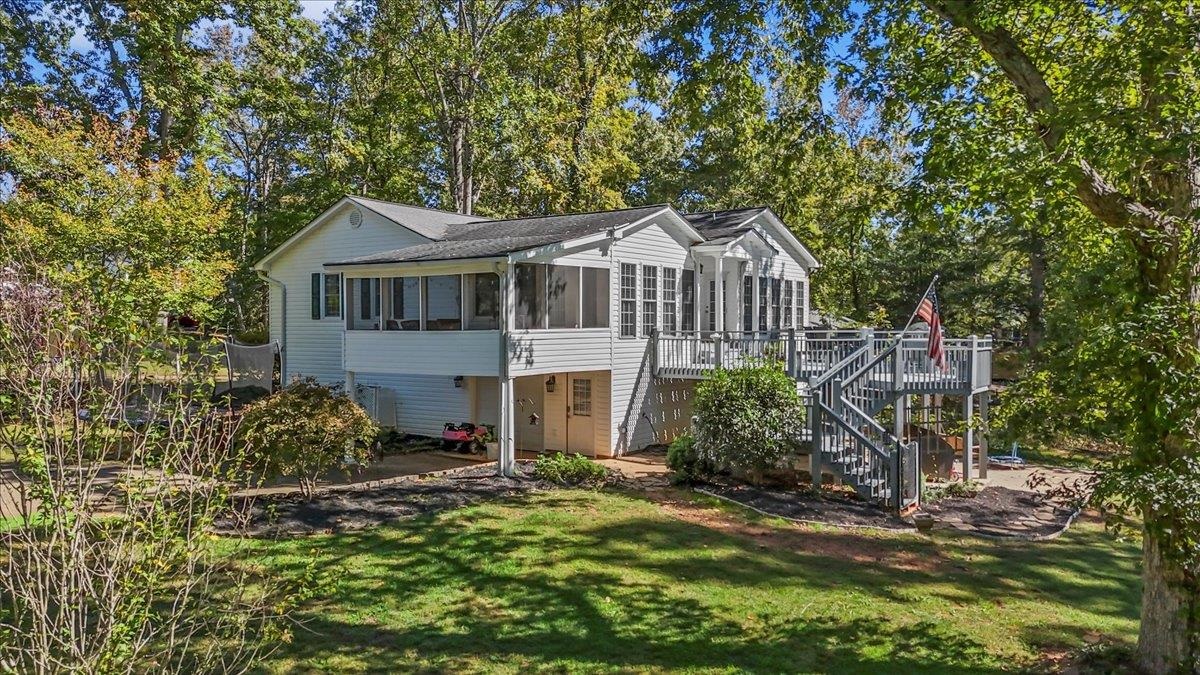 Welcome to your dream home on the serene shores of coveted Lake Bowen! This expansive 2,922 sq. ft. residence offers 4 bedrooms and 2.5 bathrooms, perfectly blending luxury, comfort, and breathtaking lakefront living. Nestled on a premier .9-acre, gently sloping lot, this property boasts unparalleled views and direct water access. Step inside to an open-concept main floor, where a gorgeous lake view sets the stage for everyday living and entertaining. The master suite flows seamlessly into a tranquil sunroom, perfect for morning coffee or evening relaxation overlooking the water. An oversized office bathed in natural light provides an ideal work-from-home space. The finished basement is a standout feature, offering a spacious bedroom, a half bathroom, and a large additional living area—perfect for guests, a rec room, or a private retreat. The basement-level garage provides ample storage and parking space. Outside, enjoy an expansive back deck, ideal for gatherings or simply soaking in the peaceful ambiance of the lake. The property includes a beautiful covered dock with power, situated in a quiet cove with low water traffic, ensuring a peaceful waterfront experience. Located just 15 minutes from the eclectic charm of downtown Landrum and 27 minutes from the renowned Tryon Equestrian Center, this home combines the tranquility of lakefront living with easy access to vibrant local attractions. Don’t miss this rare opportunity to own a slice of paradise on Lake Bowen!