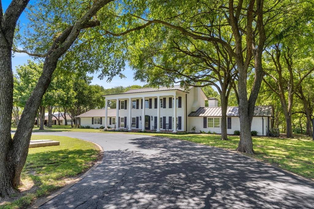 Set behind a private drive and surrounded by centuries old live oaks, this extraordinary Williamsburg-inspired manor offers a remarkable combination of timeless architecture, refined craftsmanship, and exceptional equestrian amenities on 80.54 breathtaking acres.The 7,014-square-foot main residence features five bedrooms, five full baths, two half baths, five stately fireplaces, and gracious living spaces designed for both intimate gatherings and grand-scale entertaining. The kitchen includes 2 Wolf dishwashers, 2 Subzero glass front refrigerators, 2 Subzero wine refrigerators, Wolf gas stovetop, Wolf double ovens, Wolf microwave, and a Meile built in coffee maker.Beyond the main residence, the estate is thoughtfully designed for both recreation and ranch living. Amenities include a resort-style swimming pool, an impressive 1,976-square-foot pool house, a separate three-bedroom, two-bath guest residence, a 23-stall horse barn, and a 150' x 79' covered arena with a climate-controlled viewing room.The property's natural beauty is equally impressive. Bear Creek borders the full length of the estate, while manicured pastures, mature trees, and non-climb horse fencing create an exceptional setting for equestrian pursuits or peaceful country living.Perfectly positioned just minutes from the Chisholm Trail Parkway, downtown Fort Worth, Dickies Arena, the Will Rogers Memorial Complex, world-class museums, fine dining, Clearfork shopping, and major airports, the estate also enjoys a premier location near Bluejack Ranch and the Tiger Woods-designed golf course.Whether envisioned as a private family compound, premier equestrian estate, luxury weekend retreat, or multigenerational legacy property, this exceptional offering represents one of North Texas' finest opportunities—a place where timeless elegance, unmatched privacy, and enduring memories come together.  VIDEO UPON REQUEST.