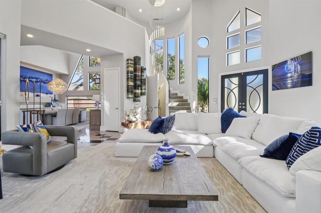 Welcome to 5801 Dove Creek, where modern luxury meets timeless sophistication! A striking contemporary estate that exemplifies architectural artistry and luxury living. This one-of-a-kind residence showcases dramatic design with soaring ceilings, geometric window lines, and an abundance of natural light that flows through every space. Step inside to discover a grand living area with floor-to-ceiling windows, an elegant fireplace, and designer finishes throughout. The home is adorned with marble and stone flooring, custom lighting installations, and high-end fixtures that create a gallery-like ambiance. Perfect for entertaining, the open-concept layout connects seamlessly to the chef’s kitchen, formal and casual living areas, and a stunning pool view. Every detail has been thoughtfully curated, from the statement staircase to the curated art niches and built-ins. Retreat to the luxurious primary suite featuring spa-inspired amenities and exceptional privacy. Additional highlights include a home office, media space, and multiple flex areas that can be tailored to your lifestyle. Nestled in a prestigious Plano neighborhood with mature trees and beautifully manicured landscaping, this property offers a rare blend of bold design, comfort, and functionality.