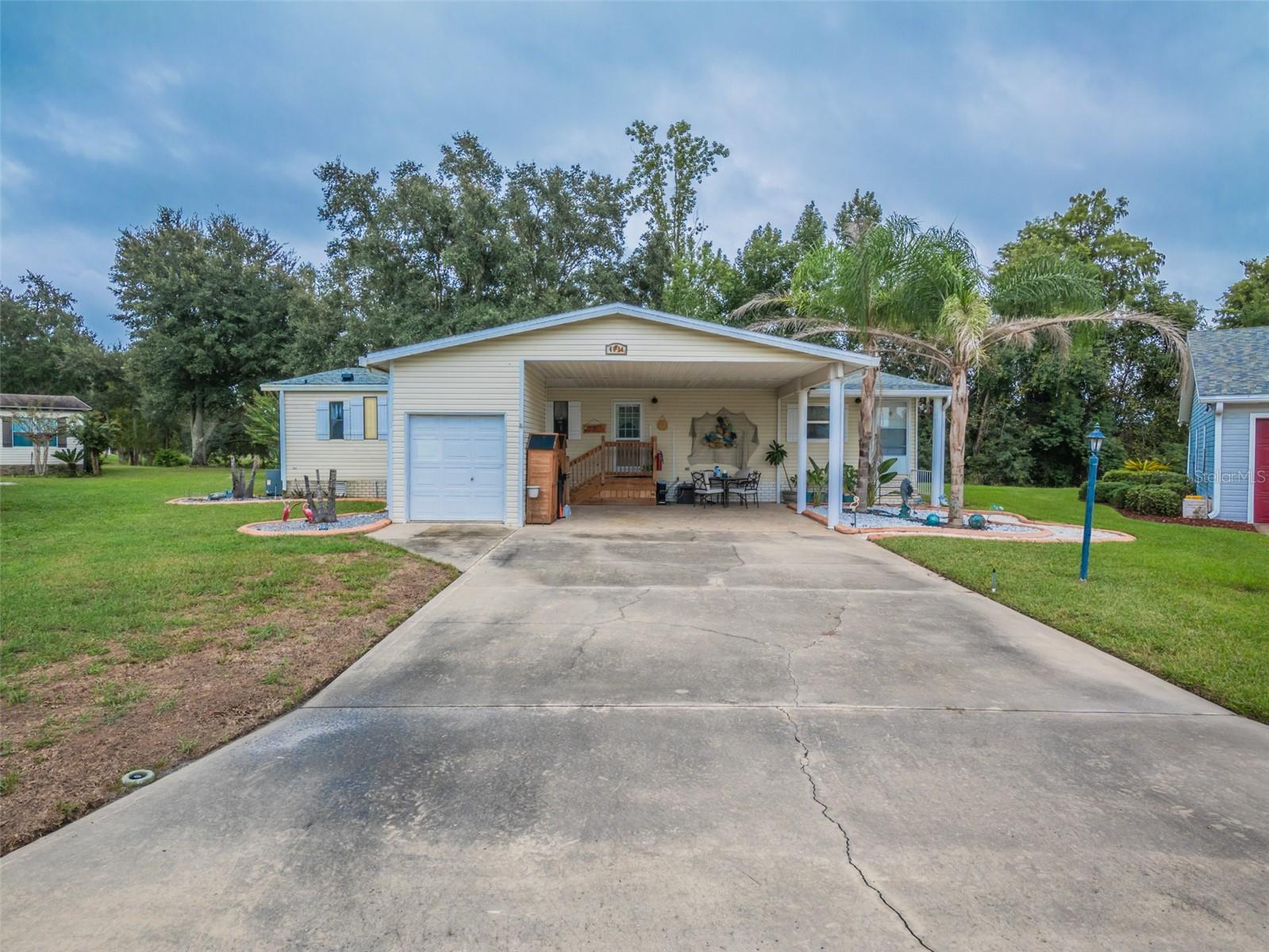 PEACEFUL POND & CONSERVATION VIEWS + RESORT-STYLE 55+ LIVING! Welcome to 4634 Belle Grove, tucked away on a quiet cul-de-sac in the highly desirable Plantation at Leesburg. This spacious 2-bedroom, 2-bath home offers approximately 1,692 square feet of comfortable living space with a layout designed for both everyday living and entertaining.Inside, you'll find generous living and dining areas, an eat-in kitchen with abundant cabinetry and counter space, and a bright Florida room where you can relax and enjoy the peaceful setting. The primary suite offers a private bath with dual sinks and an oversized shower, while the second bedroom provides plenty of space for guests, an office, or hobbies. Additional highlights include wood flooring, double-pane windows, inside laundry, a 2-car carport, golf cart garage, and a long driveway offering ample parking.Step outside to one of the home's best features—a tranquil rear setting overlooking the pond and conservation area. Enjoy your morning coffee, unwind in the evening, or simply take in the Florida scenery from your own backyard.Located in The Plantation at Leesburg, residents enjoy an active 55+ lifestyle with an incredible selection of amenities, including gated entry, multiple clubhouses and activity centers, three community pools, fitness facilities, pickleball, tennis, bocce, softball, archery, woodworking facilities, walking areas, and an extensive calendar of clubs, social events, and activities. Golf enthusiasts will love having two 18-hole golf courses right within the community, and golf-cart-friendly streets make it easy to get around and enjoy everything The Plantation has to offer.With a newer HVAC system (2023) and roof (2025), peaceful water and conservation views, and access to one of Leesburg's most amenity-rich active-adult communities, this home offers the Florida lifestyle you've been looking for. Schedule your private showing and come see what makes 4634 Belle Grove such a special place to call home!
