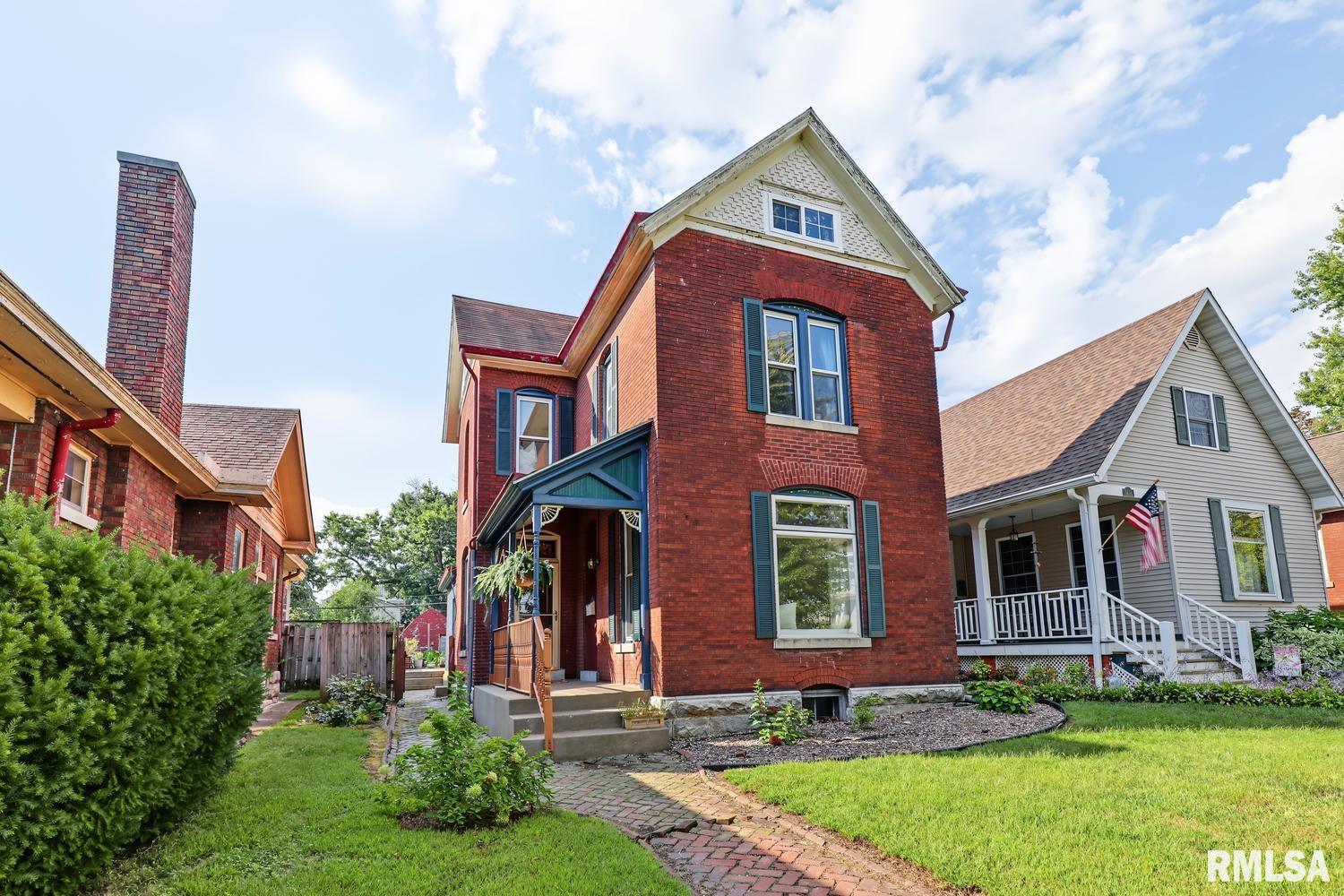 Old world charm meets modern convenience in this beautiful 3 bedroom, 1.5 bath brick home in a desirable north side neighborhood! The main floor is made for entertaining, with a spacious living room featuring a gas fireplace, generous dining room, and inviting open concept kitchen with island and breakfast bar; perfect for gathering. A convenient main floor laundry adds functionality. Upstairs are three bedrooms, a full bath, and access to a versatile third story attic space. Character abounds with gorgeous hardwood floors, exposed brick walls, and original woodwork, while modern updates include double pane vinyl replacement windows, a newer boiler system, and central air. Outside, enjoy the privacy fenced backyard filled with established perennials, plus a deck and patio for relaxing or entertaining. An adorable Quonset style building/garage provide additional storage and utility. A wonderful blend of timeless character, thoughtful updates, and comfortable modern living!
