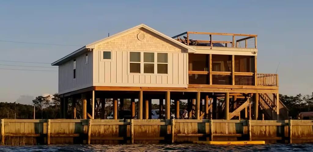 Enjoy some of the most beautiful sunsets on Virgina's Eastern Shore at "Thicket Point Fish Camp." Rare 2.5+ acre waterfront property on the Chesapeake Bay at the mouth of Onancock Creek—includes 4 contiguous bulkheaded lots. Enjoy sweeping panoramic views, water access, a new vinyl bulkhead, & endless coastal adventure. Elevated and tastefully updated home offers proven Airbnb income or makes a perfect second home retreat. Ideal for boaters, anglers, &  nature lovers— private & peaceful. Outdoor living spaces include a roof deck and screened porch. Tastefully updated in coastal chic and conveys fully furnished. Minutes from downtown Onancock which gives major "Small Town America" vibes with its charming storefronts, boutique dining options, and local art galleries. Where vacation is home.