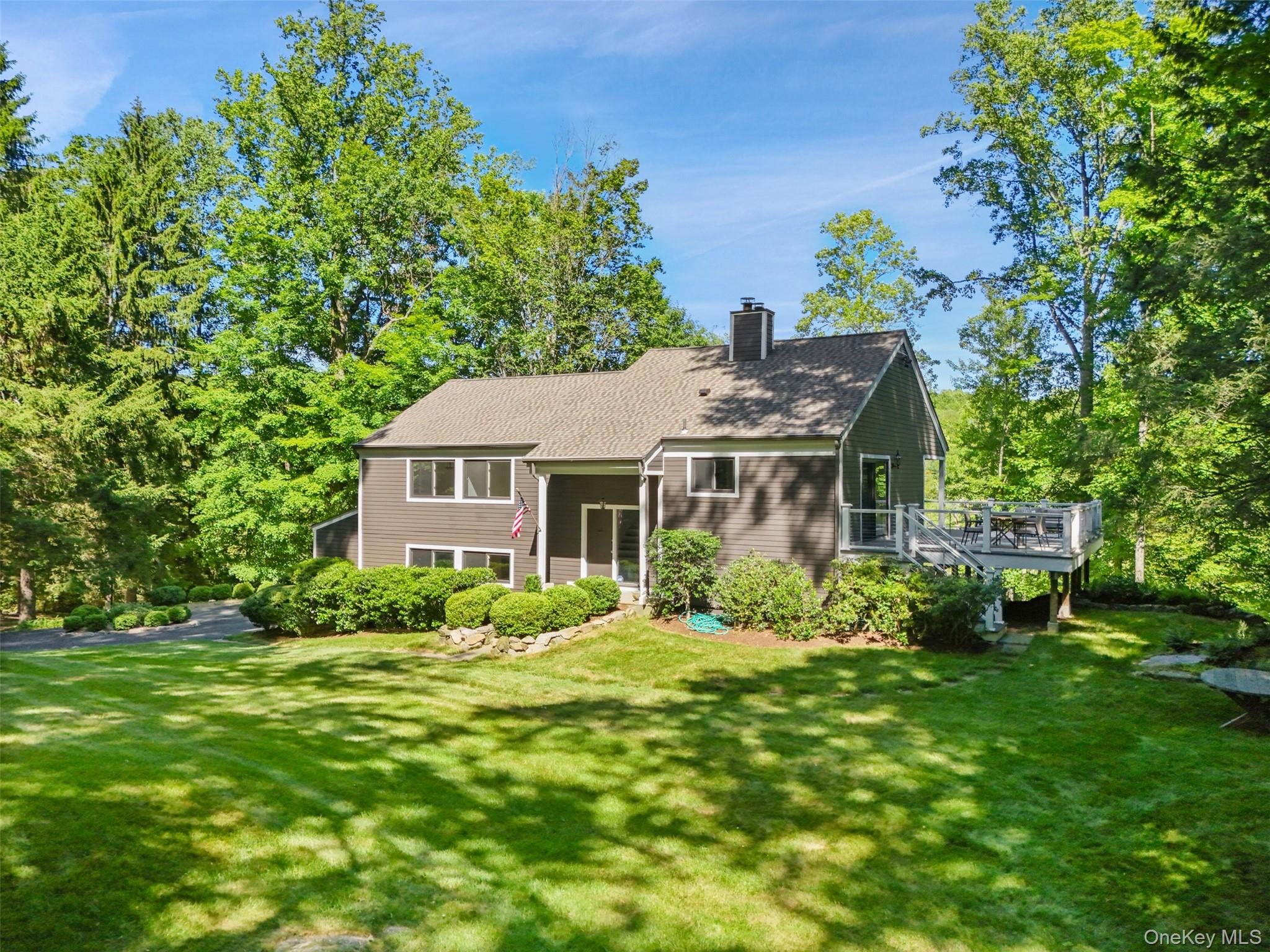 Tucked along a winding country road in a coveted estate setting, this four-bedroom, three-bath residence offers exceptional privacy on more than four acres of beautifully landscaped grounds. Age-old trees, specimen plantings, and vibrant perennial gardens frame the property, while a renovated Eat in Kitchen with expansive decks enjoy tranquil views of the picturesque pond. Expansive and open layout with hardwood floors in main living areas. Work from home in a private sunny office and enjoy winter nights by the fire in the lower level. Peaceful and secluded, entertain in style or relax in privacy. This home is not to be missed. Conveniently located just minutes from Bedford Village, Armonk, and Greenwich, within the Bedford School District.