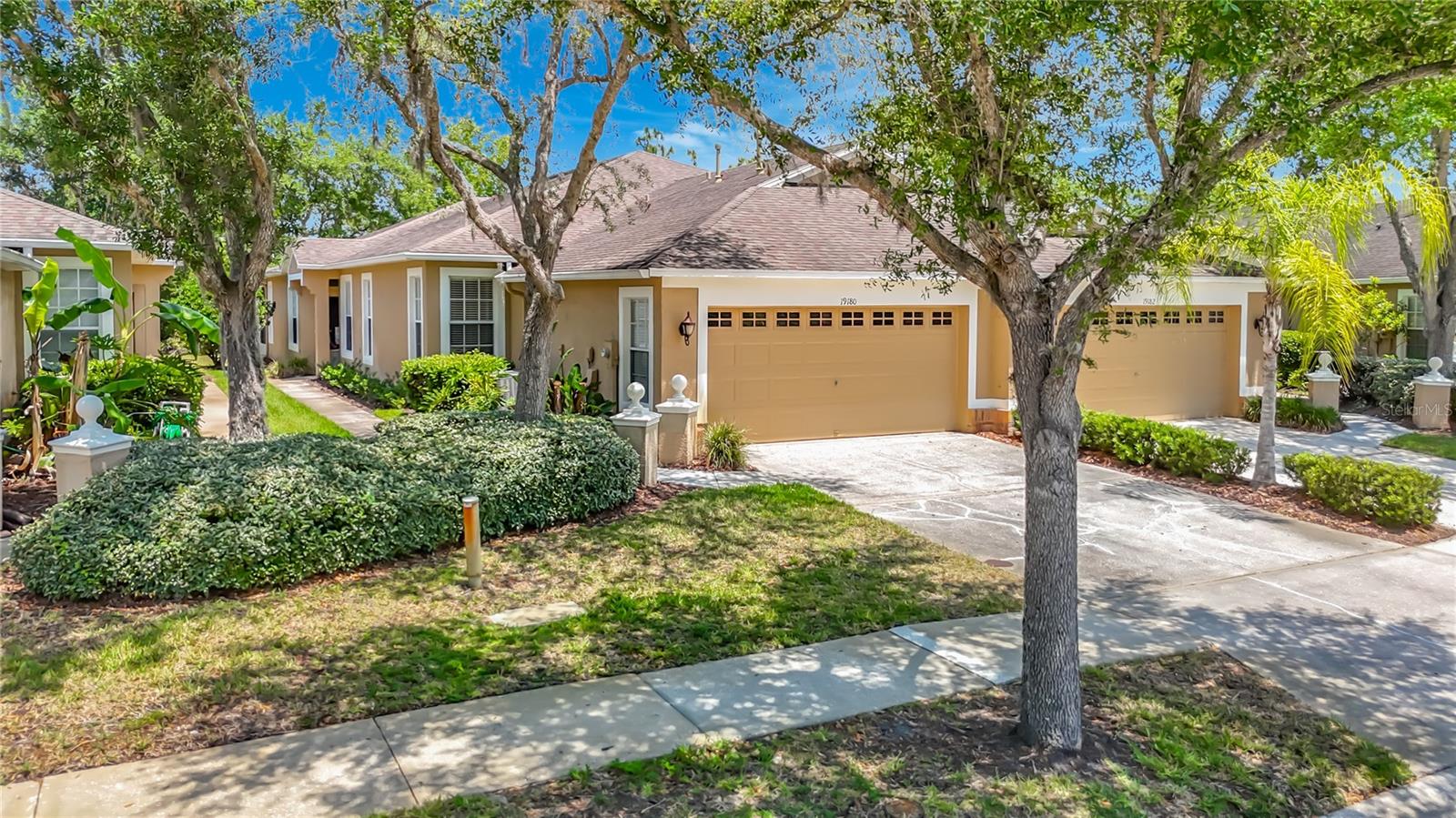 Tampa - Nestled within the gated enclave of Audubon Landing in the highly sought-after West Meadows community, this beautifully maintained 3-bedroom, 2-bath villa with a 2-car garage offers serene conservation views and an exceptional Florida lifestyle. Ideally positioned on a quiet cul-de-sac with a peaceful pond across the street, the home combines privacy, natural beauty, and convenience. Step inside to an inviting open floor plan highlighted by soaring volume ceilings and abundant natural light. The spacious living and dining areas feature triple sliding glass doors that seamlessly extend the living space outdoors, framing tranquil conservation views and creating the perfect setting for both everyday living and effortless entertaining. The light-filled kitchen offers generous cabinet storage, white appliances, a closet pantry, and easy access to the casual dining area - ideal for relaxed meals and gatherings. The primary suite serves as a private retreat, complete with a comfortable sitting area, dual closets, and sliding glass doors that open directly to the outdoor living space overlooking the conservation area - an ideal spot to unwind at the end of the day. The expansive en suite bath features a dual-sink vanity, walk-in shower, garden tub, and private water closet. Secondary bedrooms are spacious and well-appointed with built-in closets and share a conveniently located hall bath. A dedicated laundry room includes a washer and dryer along with additional storage shelving for added functionality. Enjoy year-round outdoor living from the covered lanai, where peaceful natural surroundings create a relaxing extension of the home. Residents of Audubon Landing enjoy access to their private community pool, along with full use of West Meadows’ resort-style amenities, including a water-slide pool, lap pool, fitness center, tennis, pickleball, and basketball courts, volleyball, playground, dog park, and scenic walking trails. The HOA provides exceptional value, covering roof repair and replacement, exterior maintenance and painting, grounds maintenance, and community pool access - offering a truly low-maintenance lifestyle. Located near highly rated schools, medical facilities, shopping, dining, and entertainment, this home presents an outstanding opportunity to enjoy comfortable, maintenance-friendly living in one of New Tampa’s most desirable communities. Schedule your private showing today and experience the comfort, convenience, and natural beauty this exceptional home has to offer.