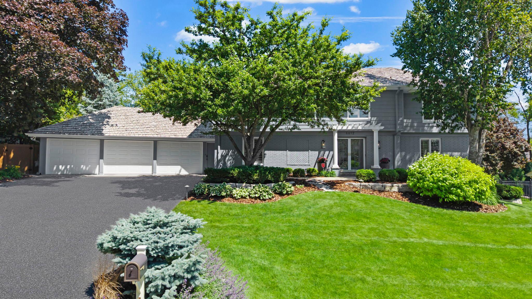 Welcome to a truly exceptional retreat in Edina’s coveted Parkwood Knolls neighborhood. Set on a private, beautifully landscaped .35-acre lot, this meticulously renovated home offers over 4,500 finished square feet with 4 bedrooms, 5 bathrooms, and a heated 3-car garage. Thoughtfully updated throughout, the home blends timeless design with modern luxury, showcasing high-end finishes, smart home technology, and an effortless sense of comfort and sophistication. The main level offers inviting and flexible living spaces, including a vaulted formal dining room with a wood-burning fireplace, a warm family room, and a versatile front living room ideal for an office, playroom, or sitting area. The chef’s kitchen features HanStone quartz countertops, a large center island, premium stainless appliances including a 48” Dacor gas cooktop and double oven, and elegant gold LED pendant lighting. A standout four-season porch with vaulted ceilings, skylights, new double-pane windows, and a mini split system with heating and A/C creates seamless indoor-outdoor living with direct access to the backyard oasis. The main level also includes a well-appointed laundry room with an updated half bath, along with direct access to the oversized heated garage featuring epoxy floors, mini split heating and cooling, and smart controls.Upstairs, the home offers three bedrooms, including a spacious primary suite with a private office, spa-like ensuite with steam shower, heated floors, dual vanities, and a generous walk-in closet. Two additional bedrooms share an updated full bath with a dual vanity. The finished lower level is designed for entertaining, featuring a spacious family room with custom built-ins, wet bar, fourth bedroom, and updated bath, along with generous storage and a new furnace (2023). The resort-style backyard is a true highlight, offering a fully fenced yard, in-ground pool with new pool deck surface (2026), terraced Fond du Lac stone patio, separate fenced green space, and beautifully maintained landscaping for exceptional privacy and relaxation.A rare combination of luxury, function, and location—this home delivers refined living in one of Edina’s most desirable neighborhoods.