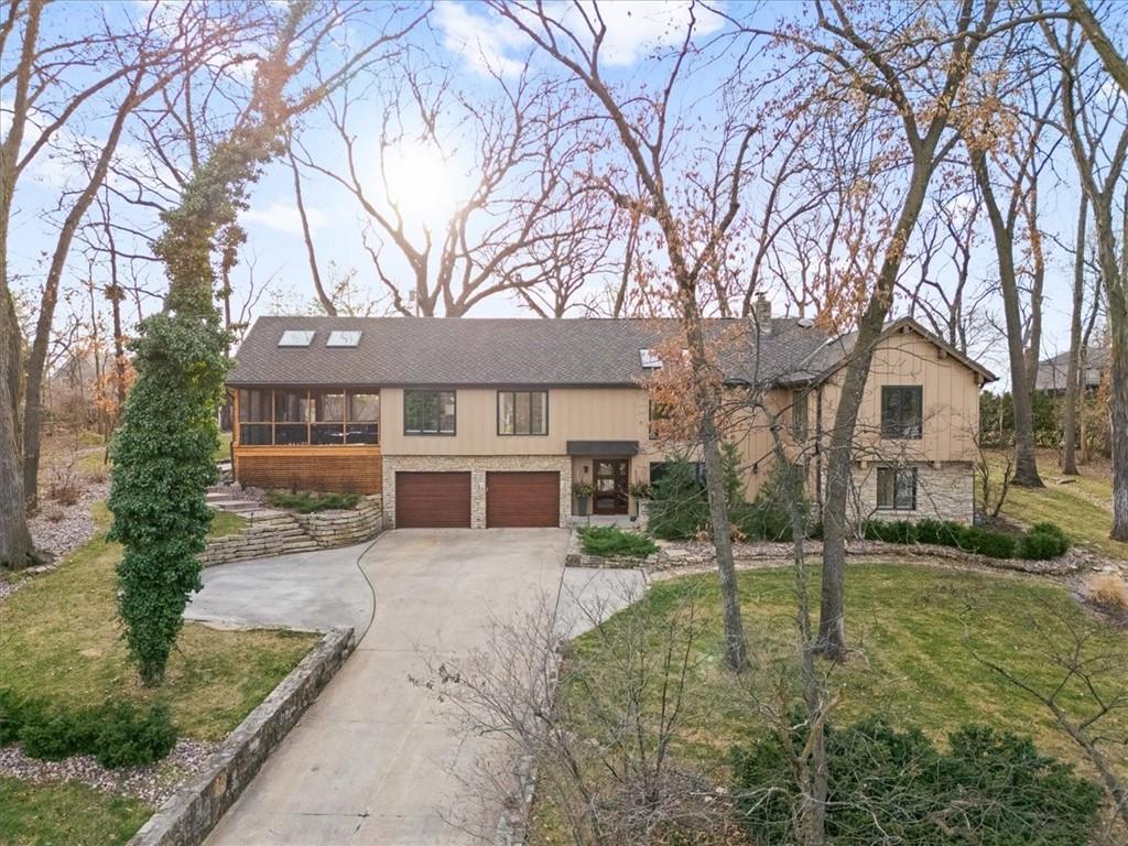 Incredible opportunity inside the secured gates of Lake Quivira -Updated throughout – Main level offers a spacious Great Room with a striking stone wall and gas fireplace, vaulted ceiling & wood flooring. Formal dining room with wood floors adjoins the spacious breakfast room & well-appointed kitchen featuring granite countertops, double oven, 6-burner gas cooktop, stainless steel appliances, pantry & newer Dacor refrigerator.  Additional main-level amenities include laundry room with built-ins & sink and a convenient half bath off the kitchen. Enjoy the fantastic 18’x25’screened porch with vaulted ceiling, fan, fireplace and outdoor TV.  Primary suite includes a generously sized bedroom, updated bath & his-&-hers closets. Three ADDITIONAL main-level bedrooms feature wood floors & ceiling fans. The hall bathroom has been updated with ceramic tile, a new shower/tub, & granite countertop.  Lower level features a cozy family room with stone fireplace, built-in bookshelves and cabinetry & a dedicated TV area. Two lower-level bedrooms & a full bath complete this space; the bath has been updated with a new shower & granite countertop.  Great wooded lot with front and back patio areas. (Stairwell & dining room light fixtures do not convey with the home).  Private dock site # 269 with nearly new steel-framed floating dock.  LQ is a private, 18-hole golf course & lake community with 24/7 gated security & many amenities to enjoy including: 220 acre private lake for boating, skiing, fishing, kayaking, sailing & swimming. Additional amenities: extensive Nature Trails system, Equestrian facilities, private, full service clubhouse, Community Center with workout facilities, lap pool, indoor & outdoor tennis and pickleball courts, exercise classes and more. One time $40,000 required membership fee and monthly HOA. (visit LakeQuivira.org for more information) MANY clubs to join, kids summer rec programs….indoor & outdoor fun & activities for the entire family & people of all ages.
